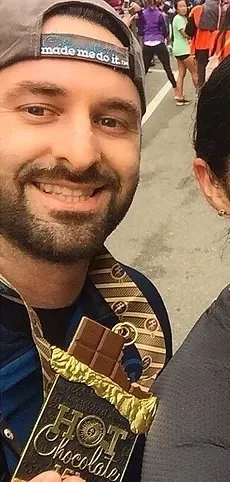 doctor koutoulas smiling with a race medal