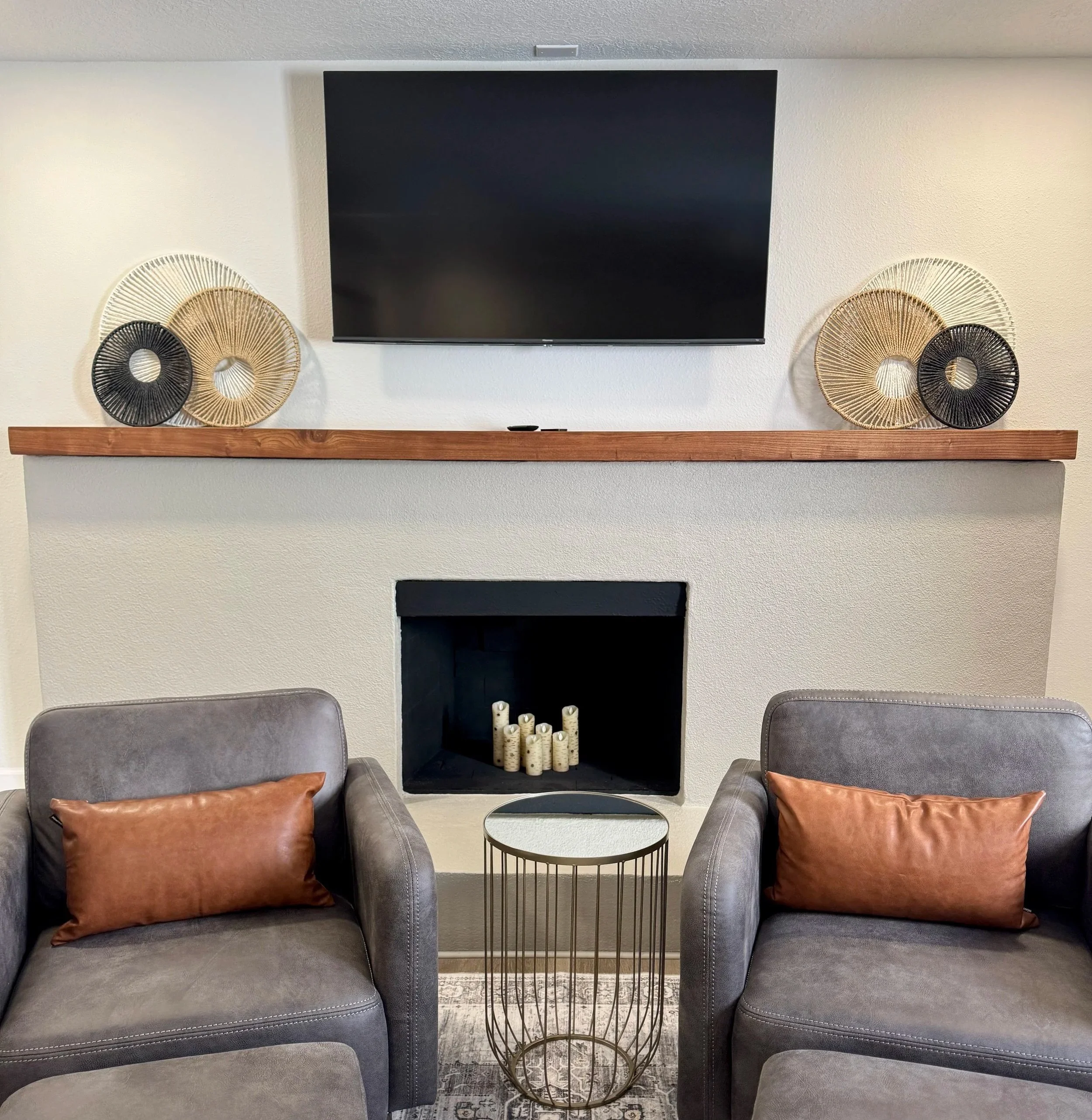 Dark wood mantle above a fireplace in a cozy setting.