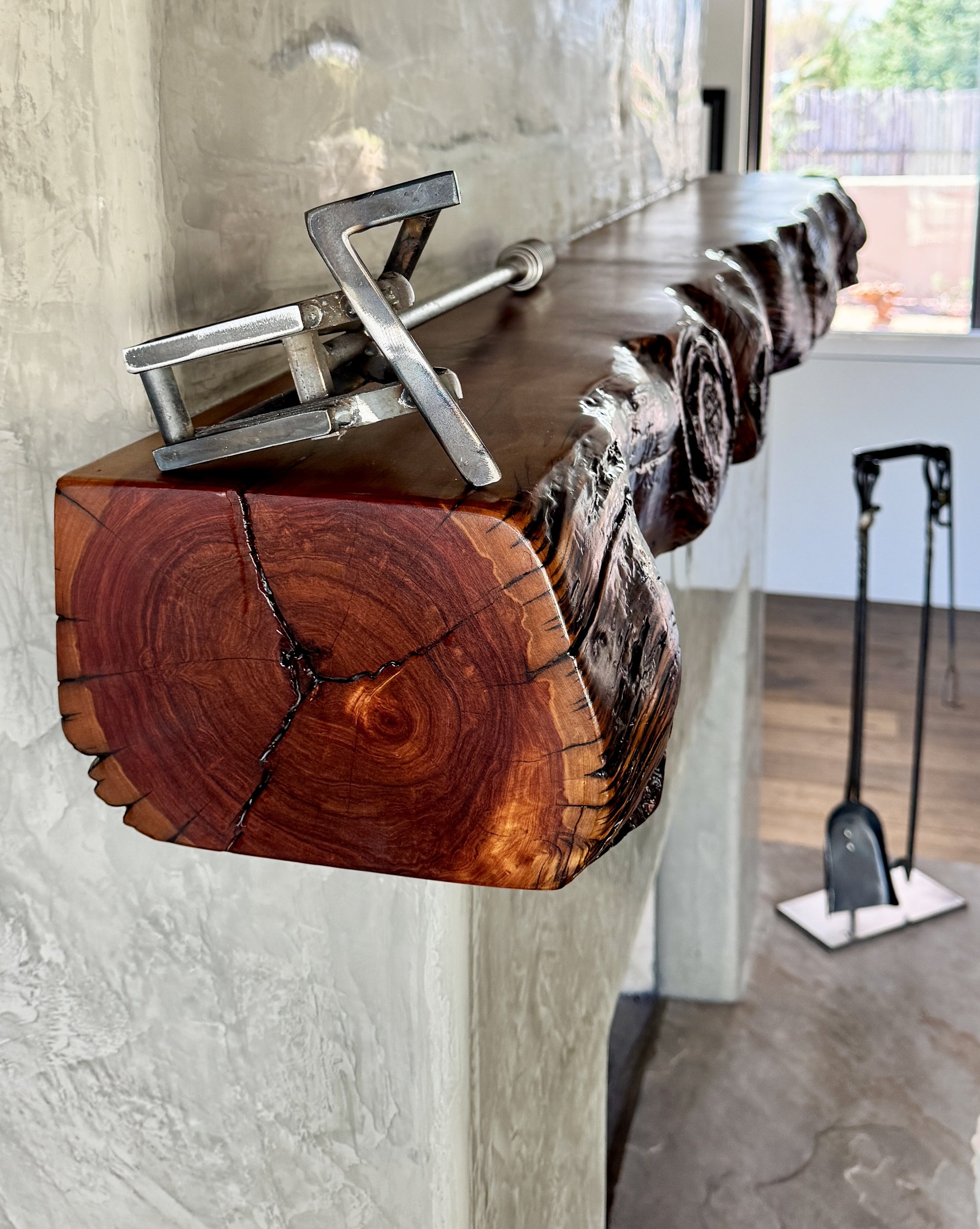 Live-edge Cedar mantle above a fireplace.