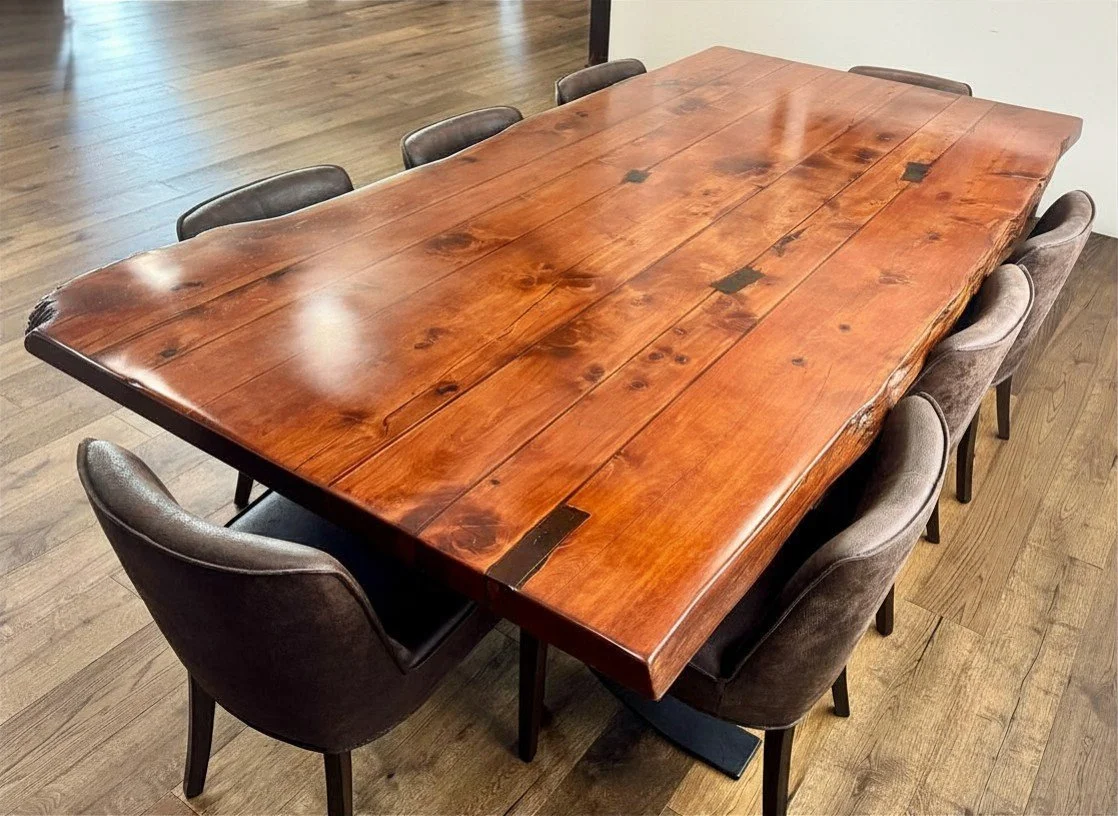 Dark wood dining table with natural edged and suede chairs.
