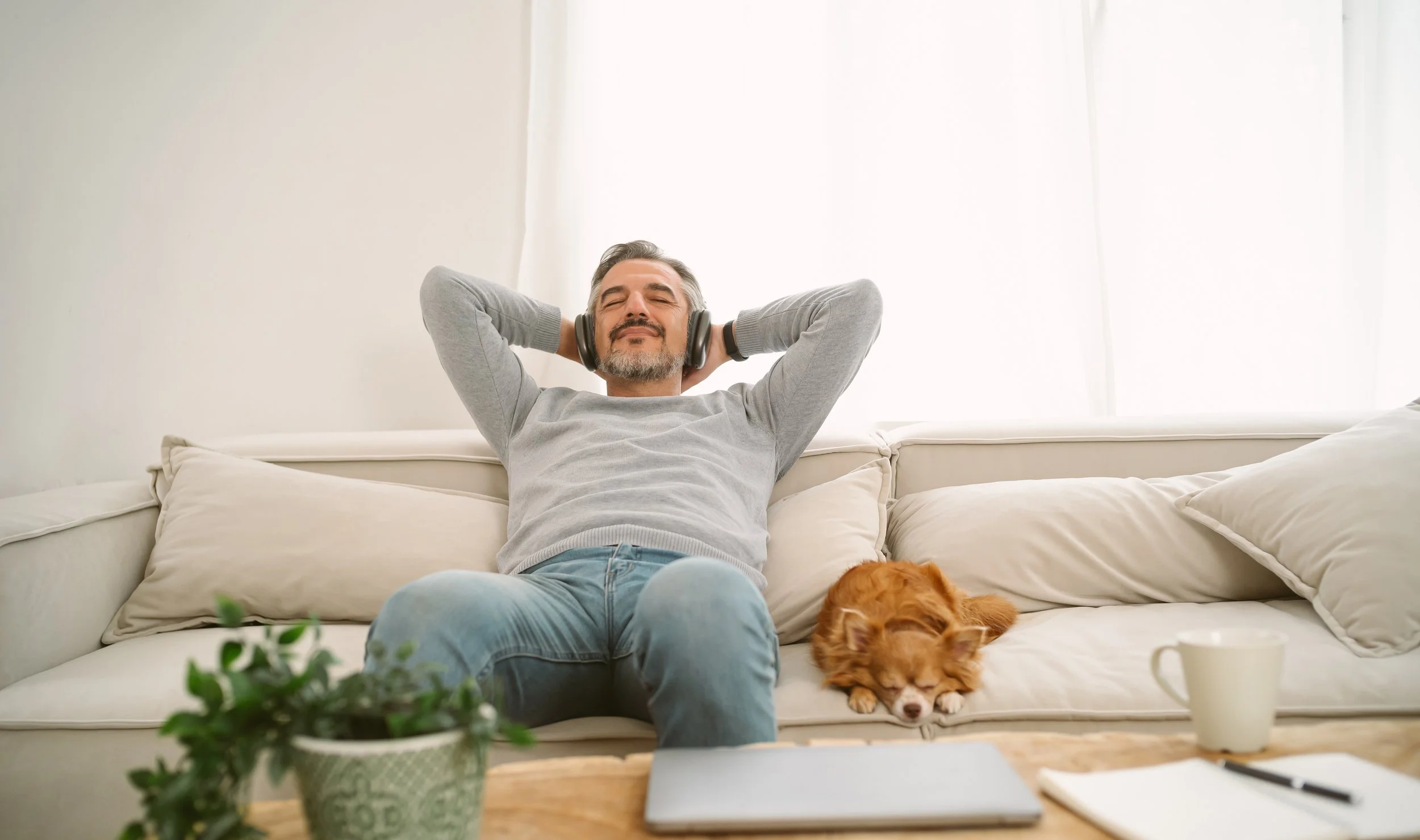 Man on couch with headphones 