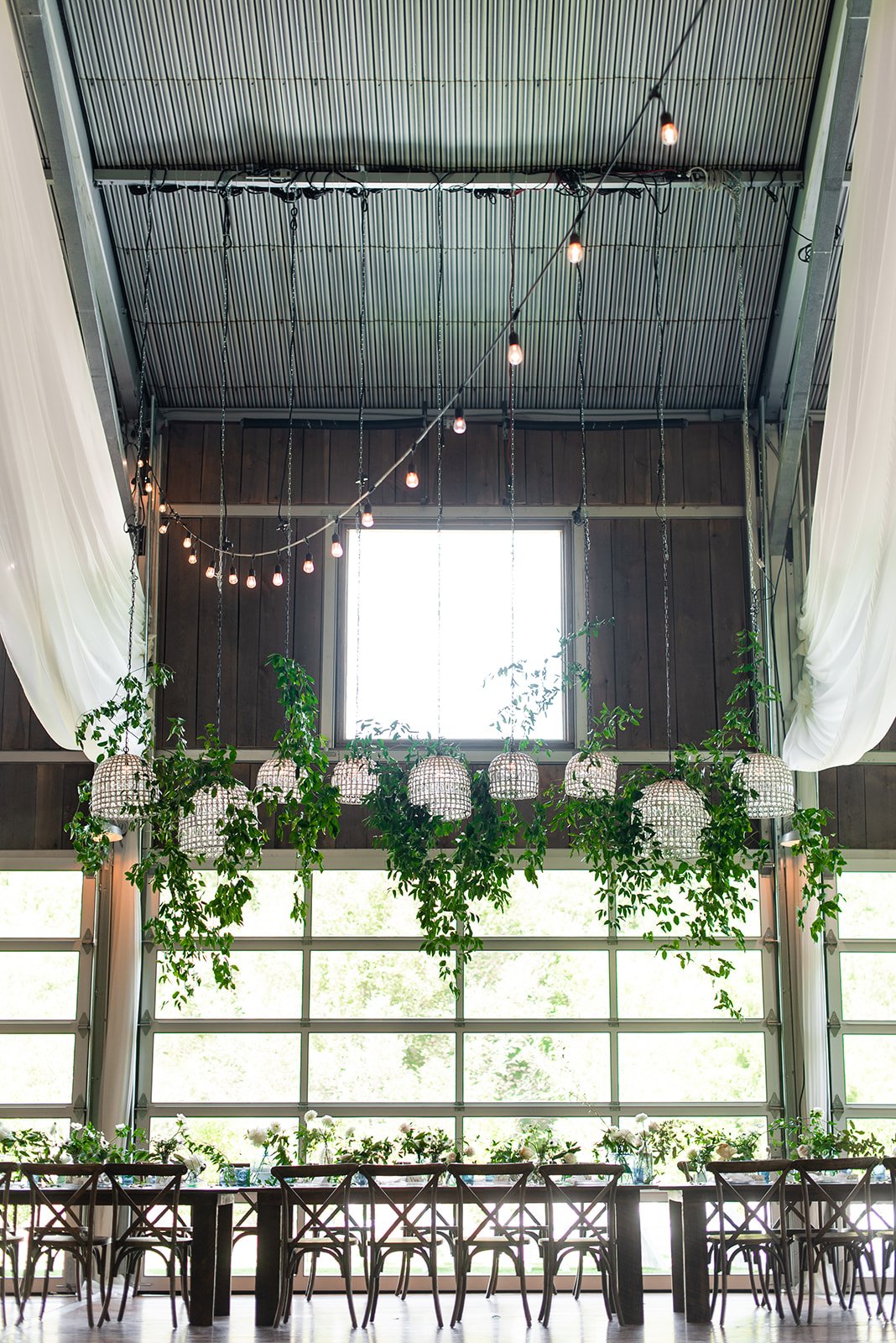 chandeliers and hanging greenery.jpeg