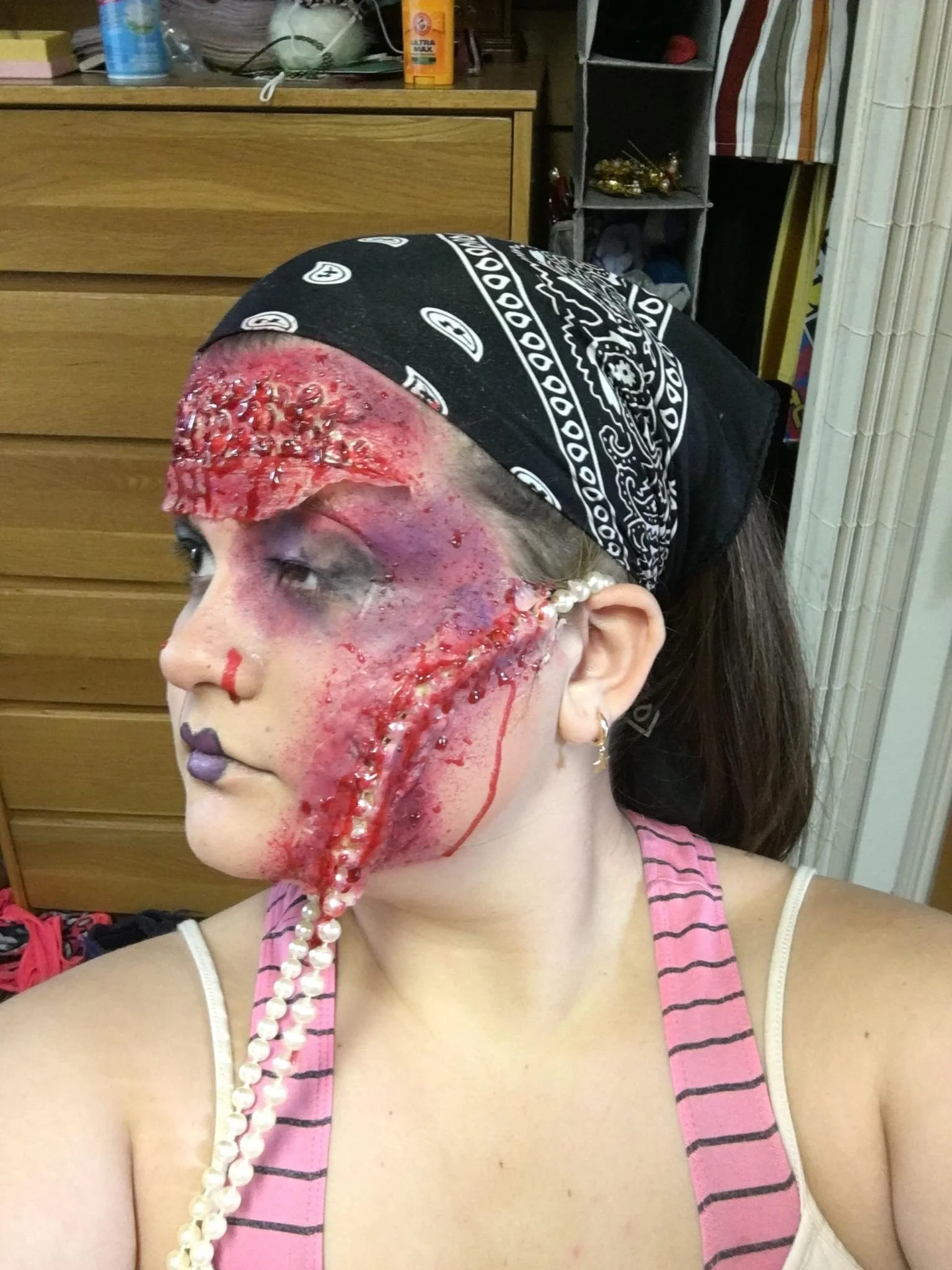 Embedded pearls secured with spirit gum, and scar wax.