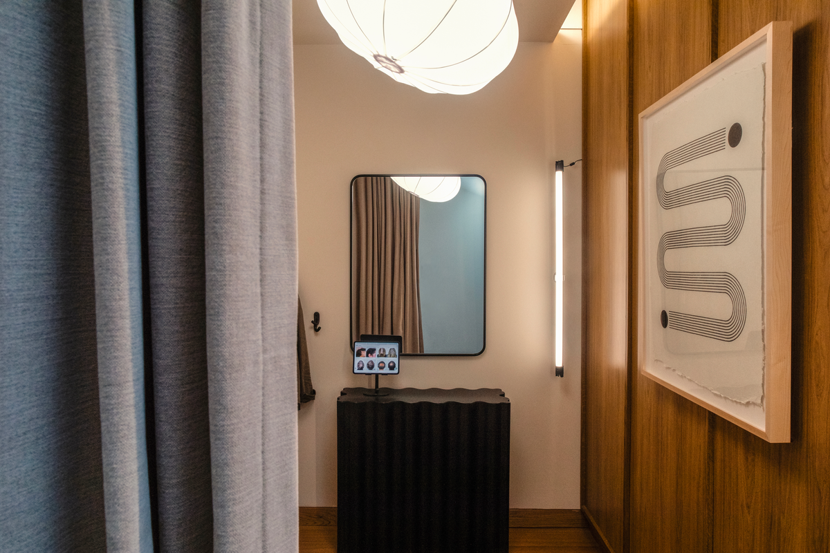 Great Many Atlanta photobooth for hair restoration progress images. A warm wood wall and gray curtain provide intimacy and comfort in the space.