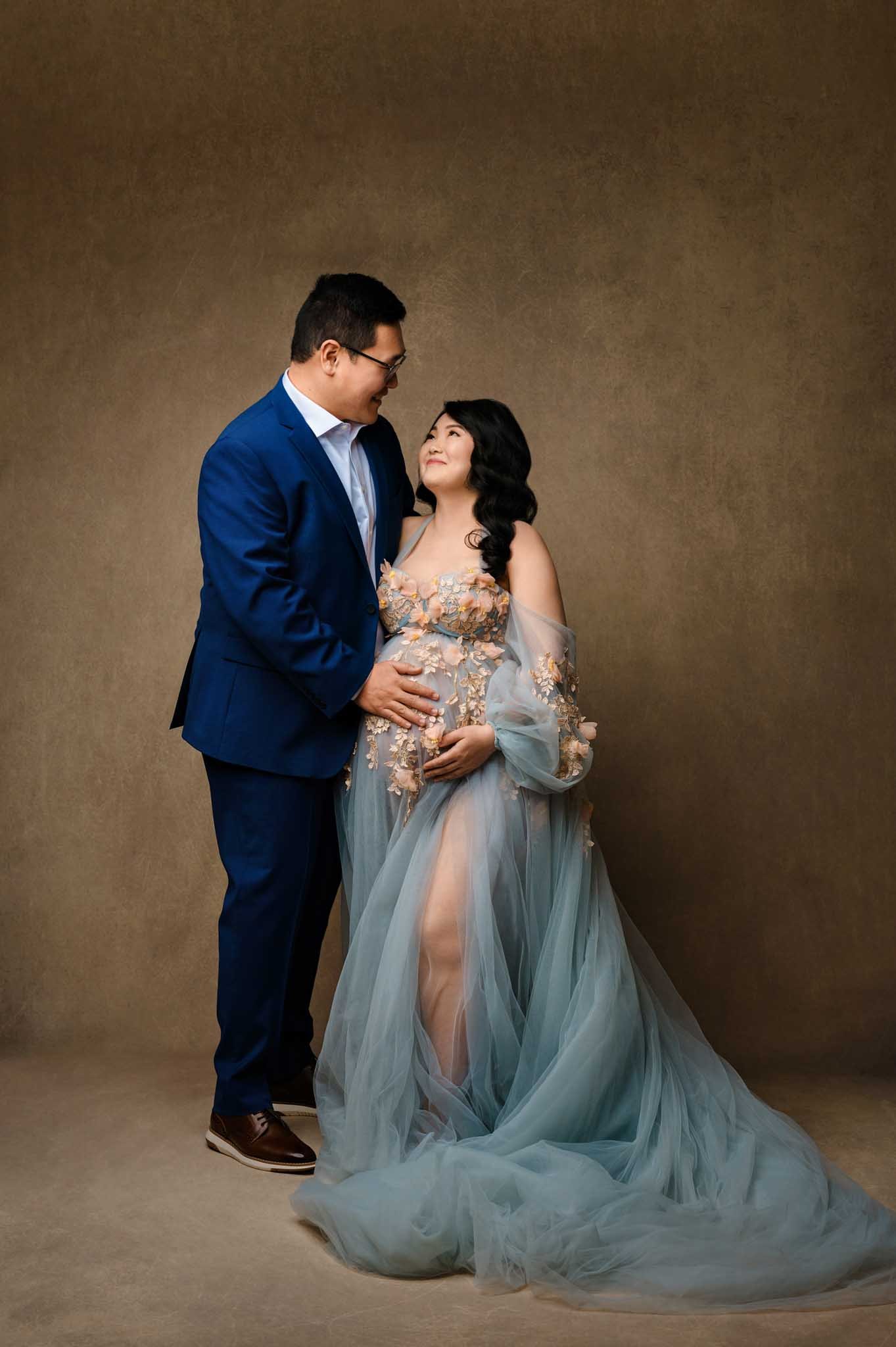 Seattle couple posing together for maternity photos in evening wear.