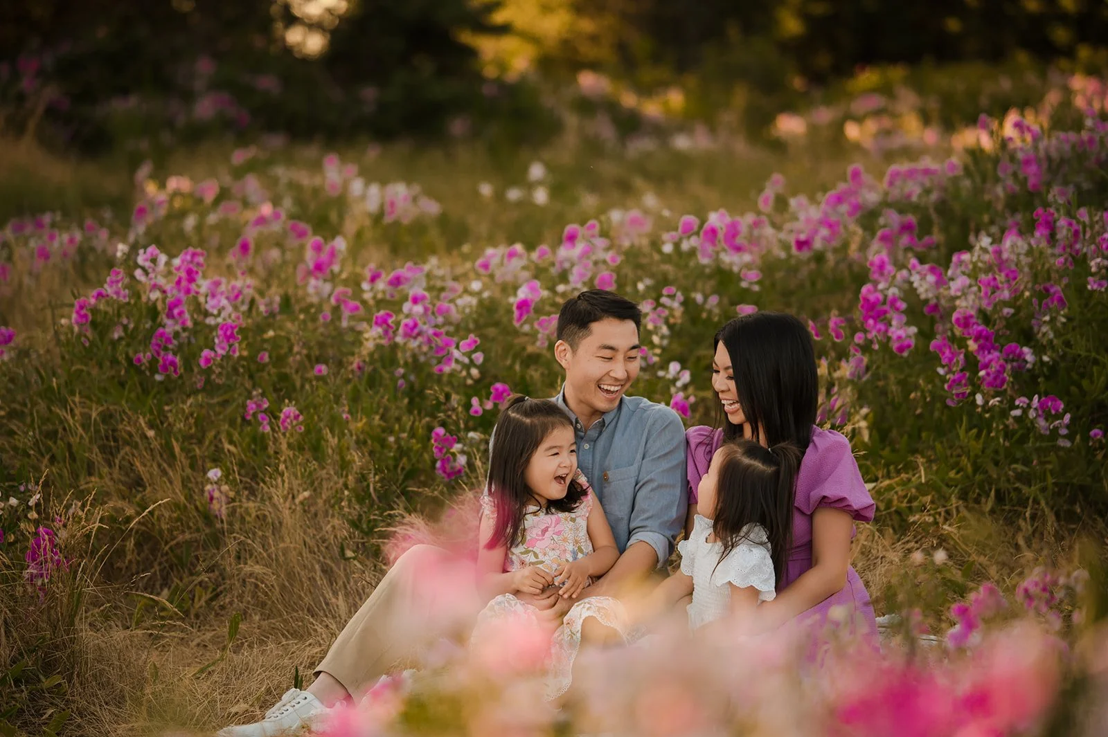 family of four enjoying their seattle photo session in the wildflowers