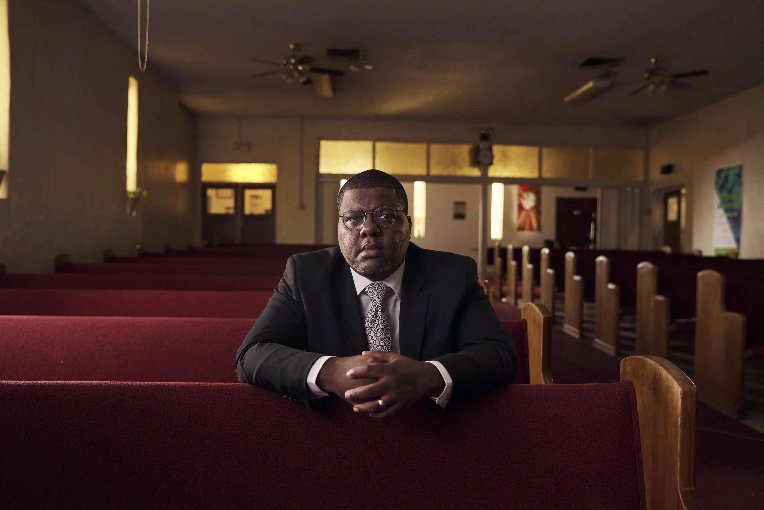 Man in suit sitting in church pew