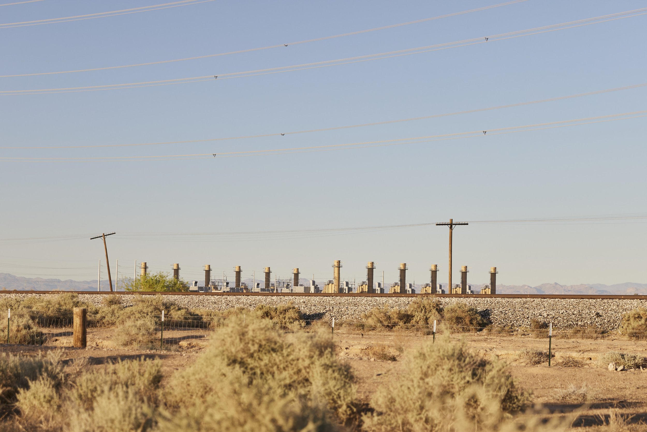 Editorial image of chimneys and infrastructure at an industrial plant in Randolph, Arizona — captured by Matt Martian, Phoenix-based photographer for documentary and reportage work
