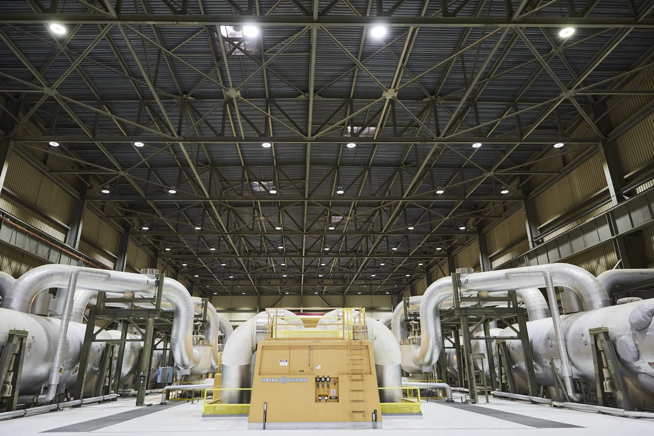 Interior of industrial facility with large pipes and machinery