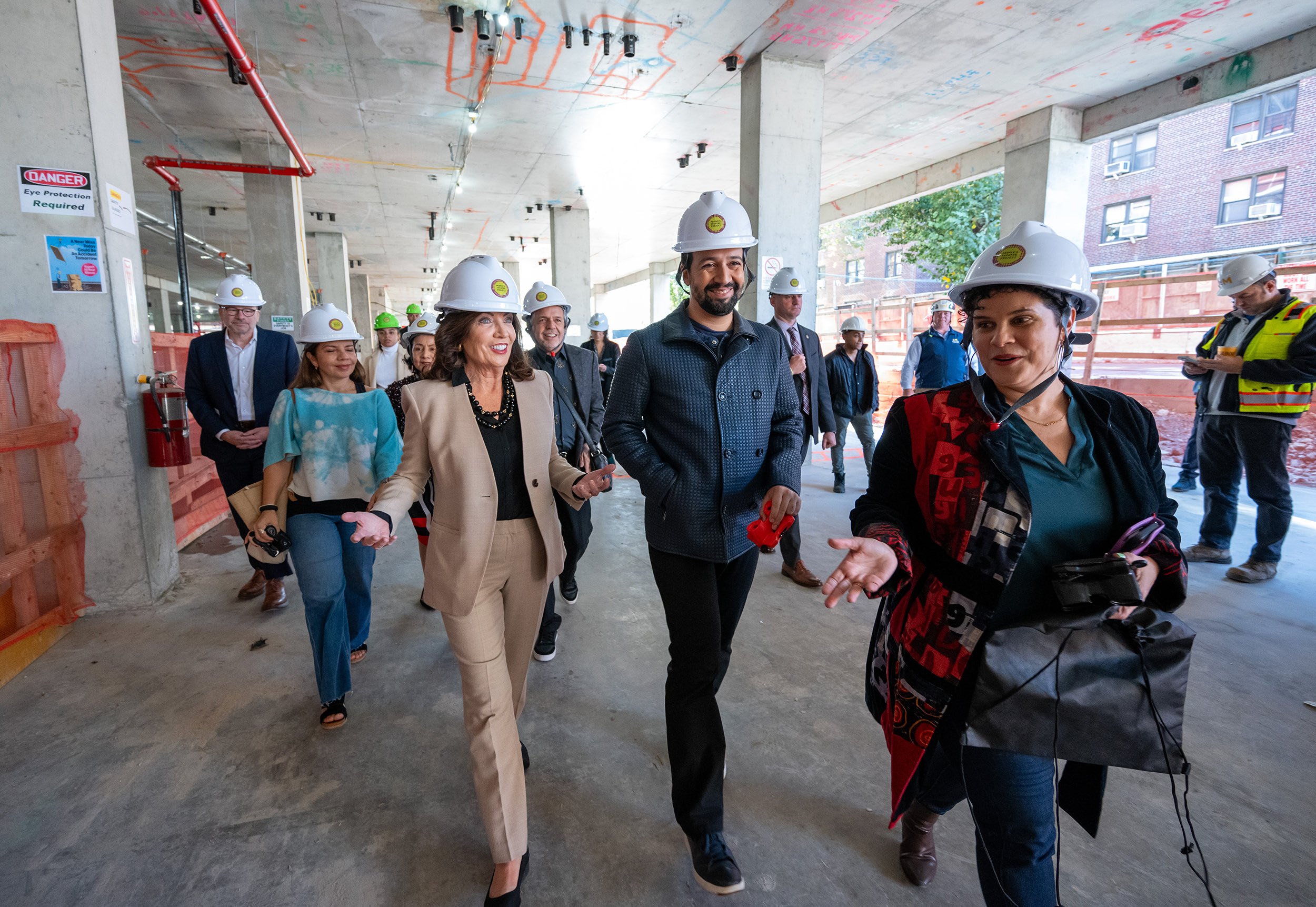 Govern Hochul, Andrew Kimball (President of NYC Economic Development Corp), Mino Lora (People’s Theatre Project co-founder) and members of the Miranda family take hard hat tour of PTP’s new arts facility.
