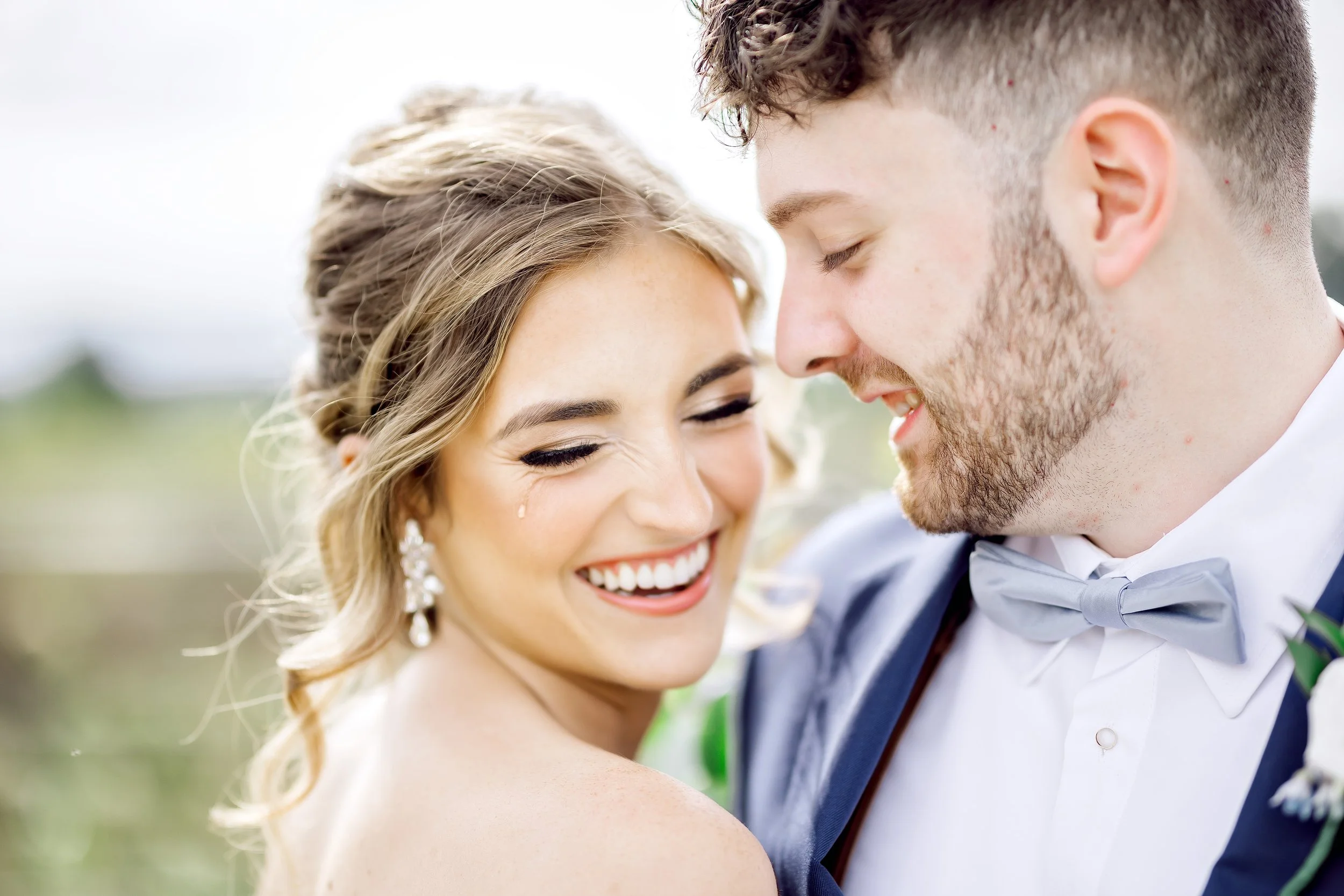 Bride and groom sharing a joyful close embrace