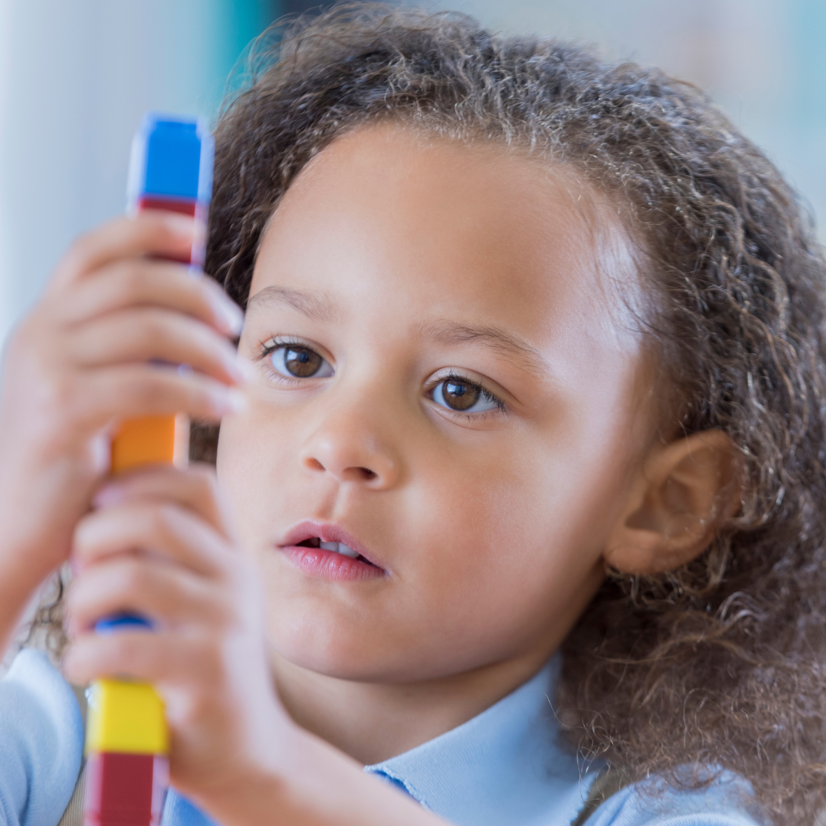 kindergarten student exploring manipulatives