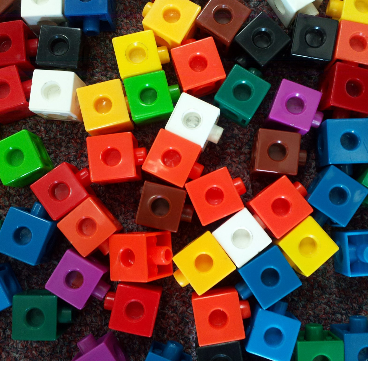different color snap cubes on a rug.