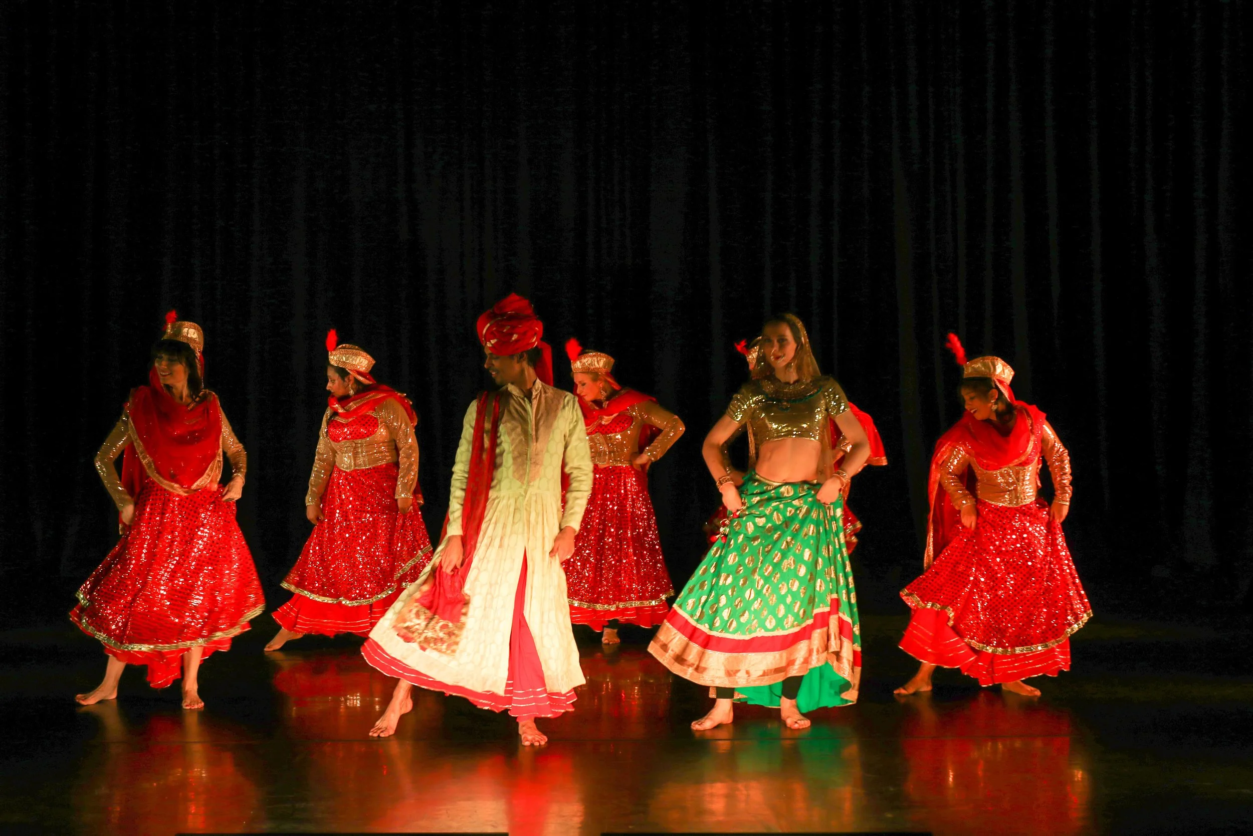 Dancers from ABC (A Bollywood Company) performing an intricate and high-energy advanced Bollywood routine.