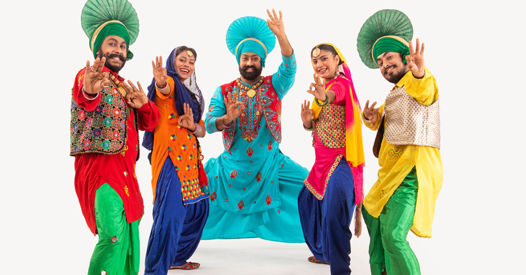 A group of dancers jumping energetically during a high-cardio Bhangra dance class at Shoonya Dance Centre in Ghent.
