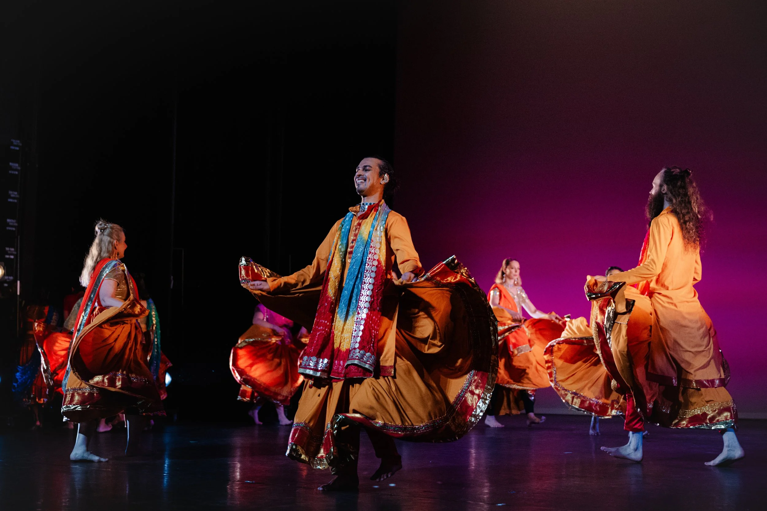 A vibrant, on-stage Bollywood dance performance showcasing dynamic energy and cinematic grace.