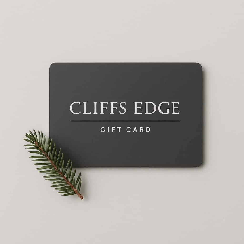 A black gift card labeled "Cliffs Edge Gift Card" with a small green pine branch on a white background.