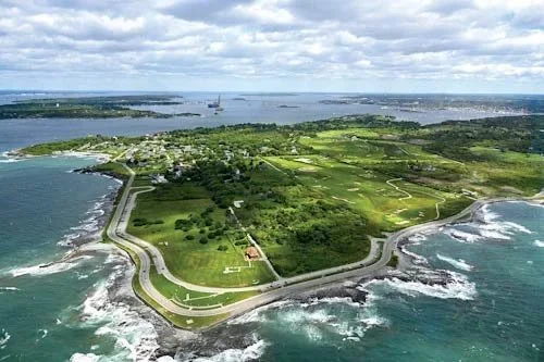Aerial image of Jamestown, RI, a look at a green landscape surrounded by ocean and islands in the distance. 