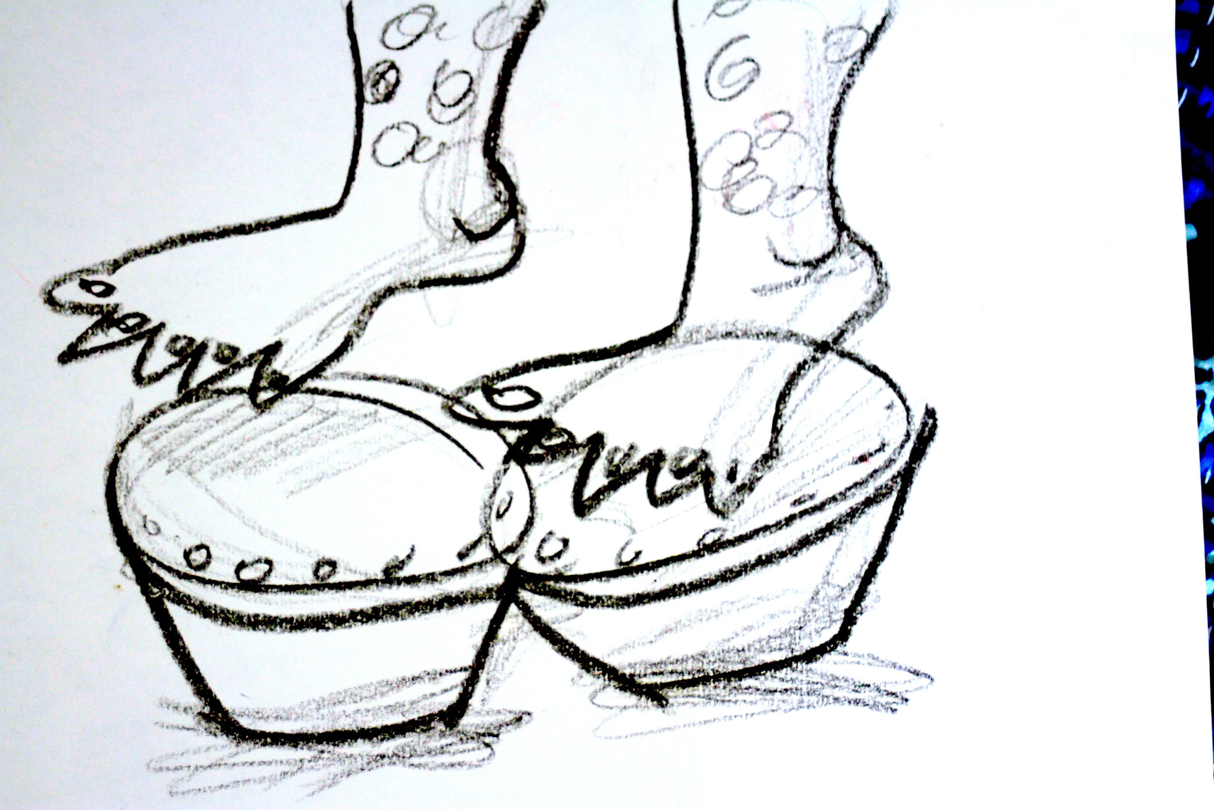 A sketch of a Halloween-themed shoe decorated with a pumpkin face and stars, with handwritten text that reads "Happy Halloween."