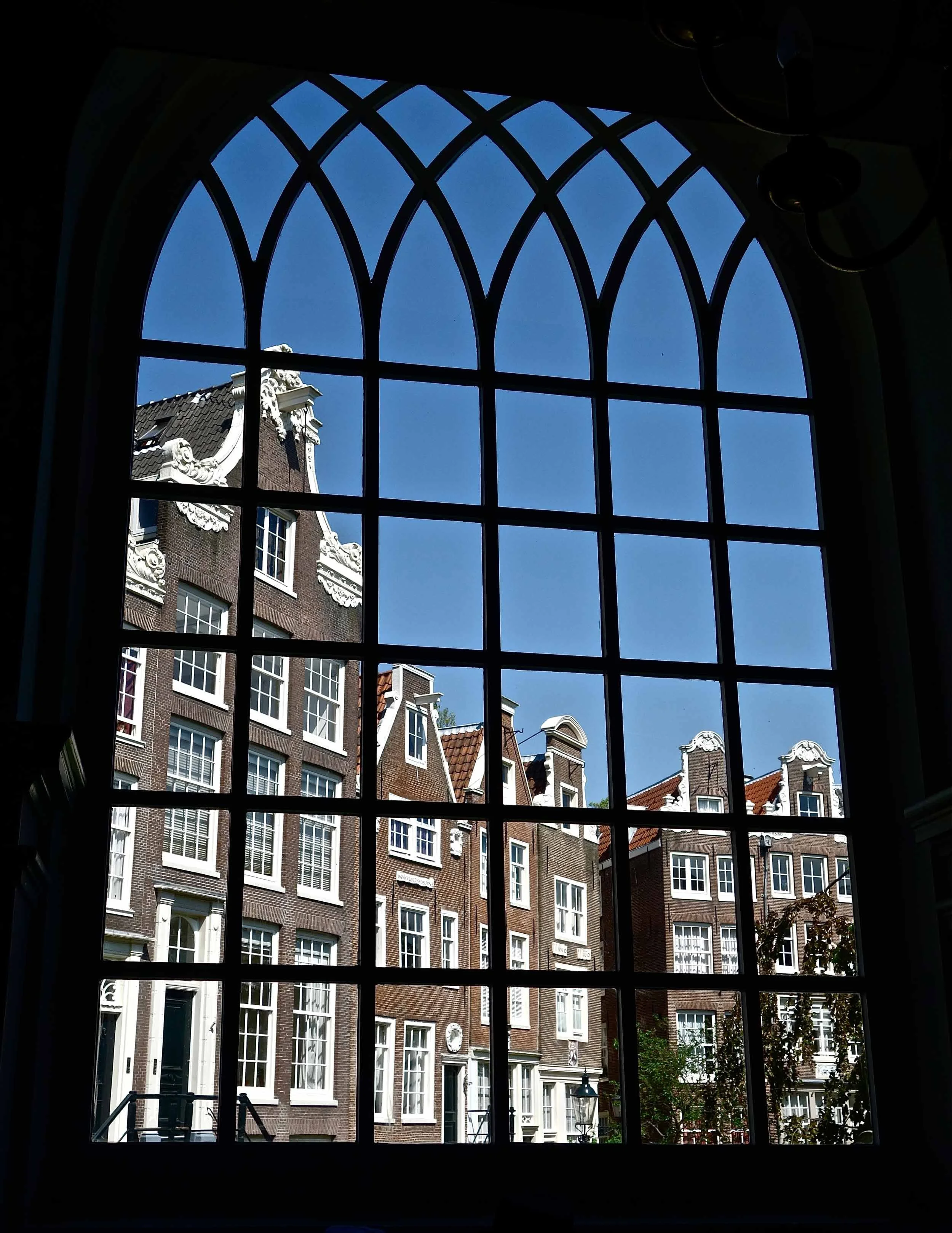 View of the Begijnhof through a church window, Amsterdam, The Netherlands