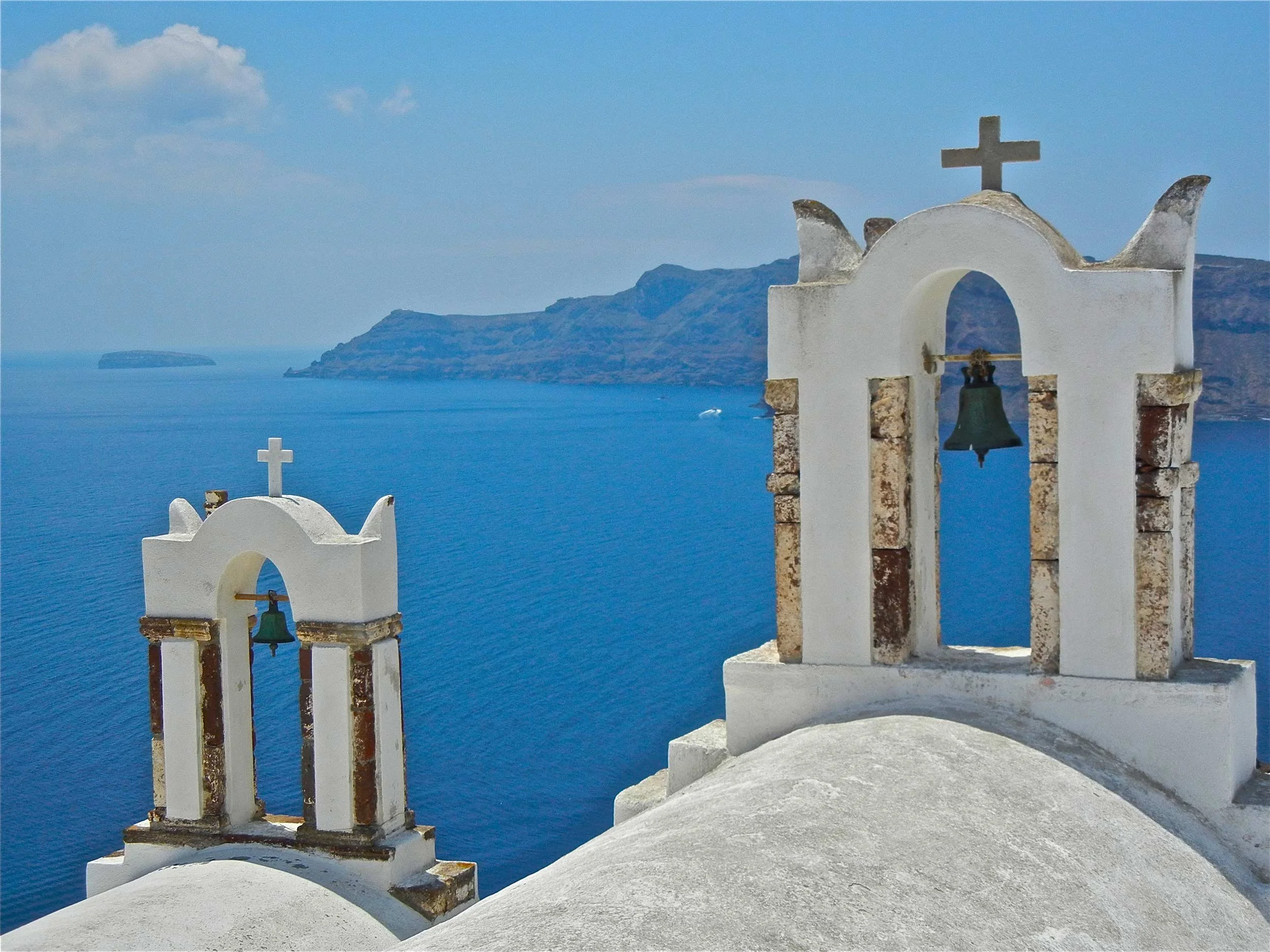 White church bell towers, Oia Village, Santorini, Greece