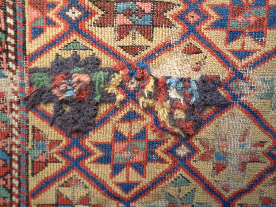 Rug Restoration Process - Hand knotting the area where the hole was re-rewoven