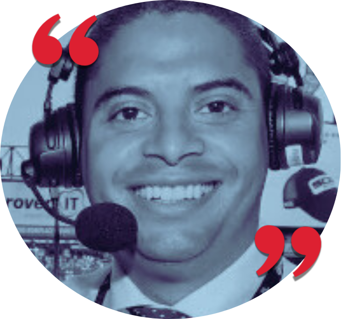 Smiling man wearing a headset and microphone, likely a radio host or commentator.