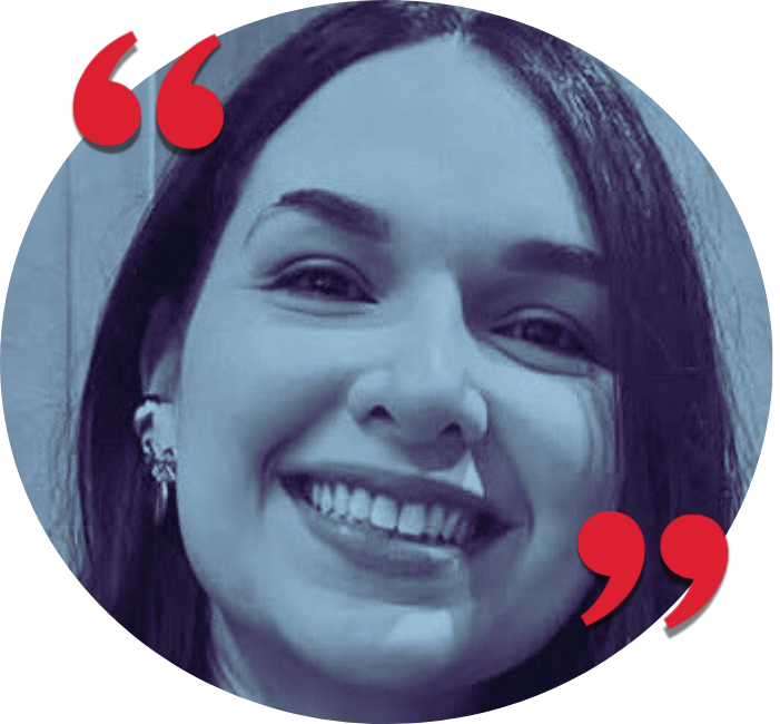A smiling woman with dark hair, wearing earrings, and showing her teeth.