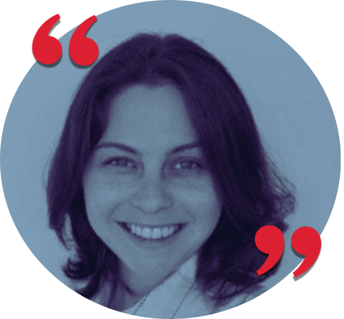 A woman with shoulder-length dark hair smiling at the camera, with red quotation marks in the top left and bottom right corners.