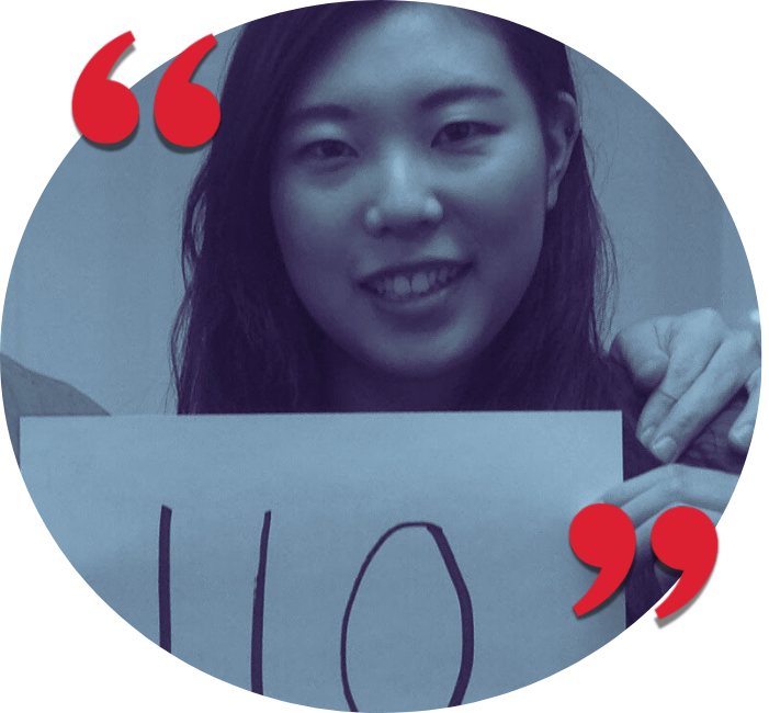 A young woman smiling while holding a sign with the number 10 on it.