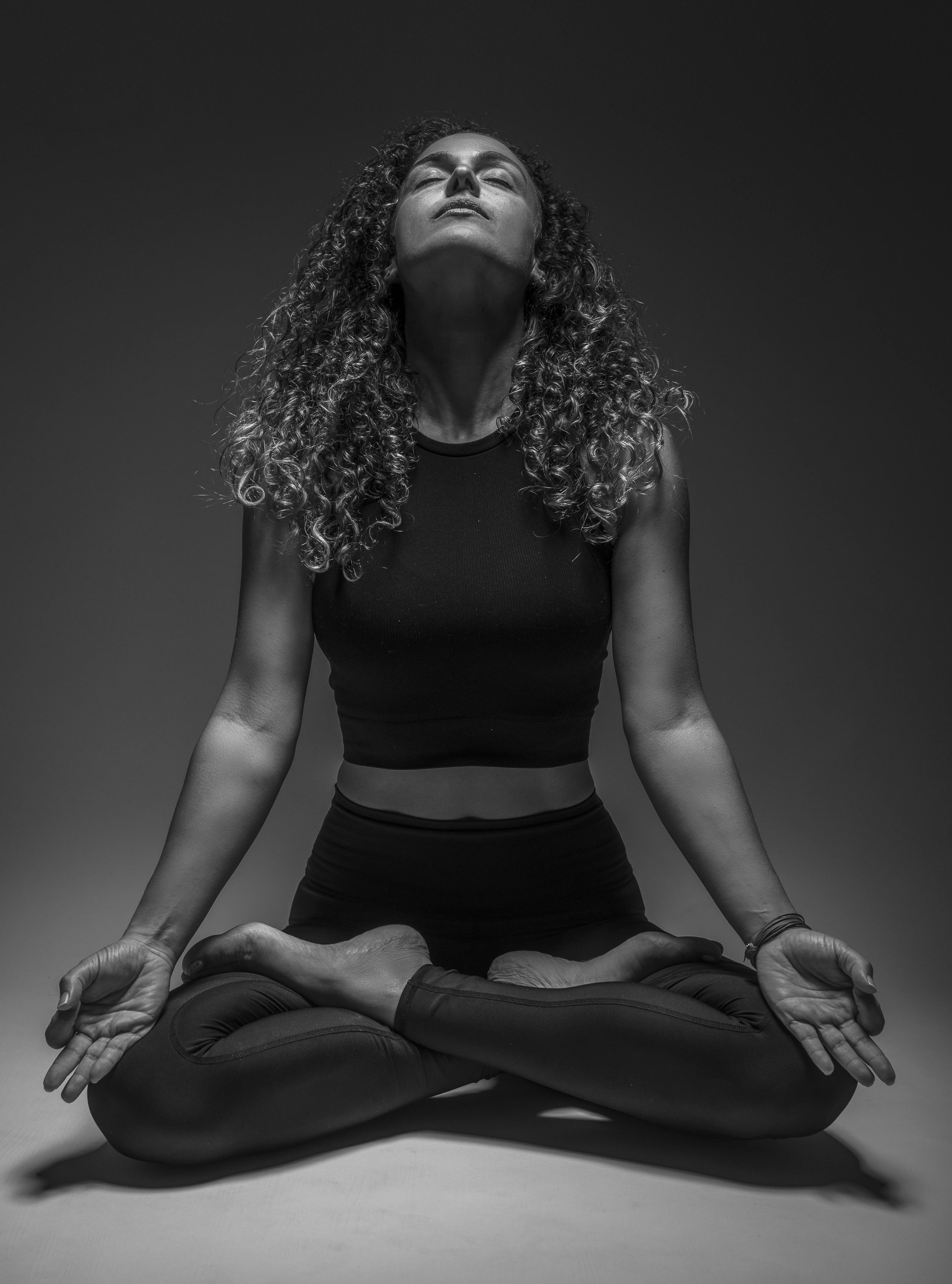 A woman in lotus position doing breath-work