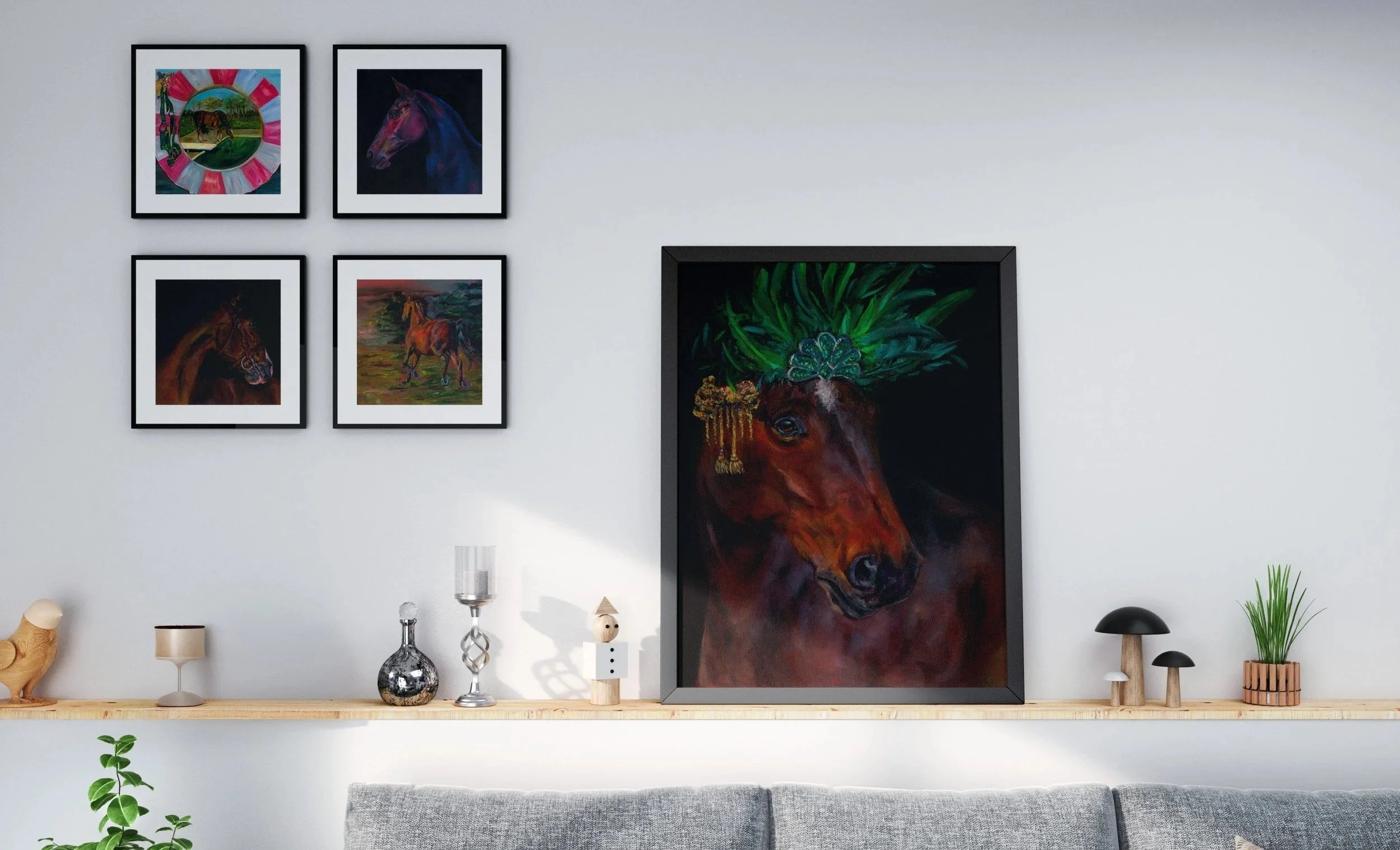 Interior living room with a gallery wall of five framed horse paintings and a large framed portrait of a horse with a green headdress on a shelf against a white wall.