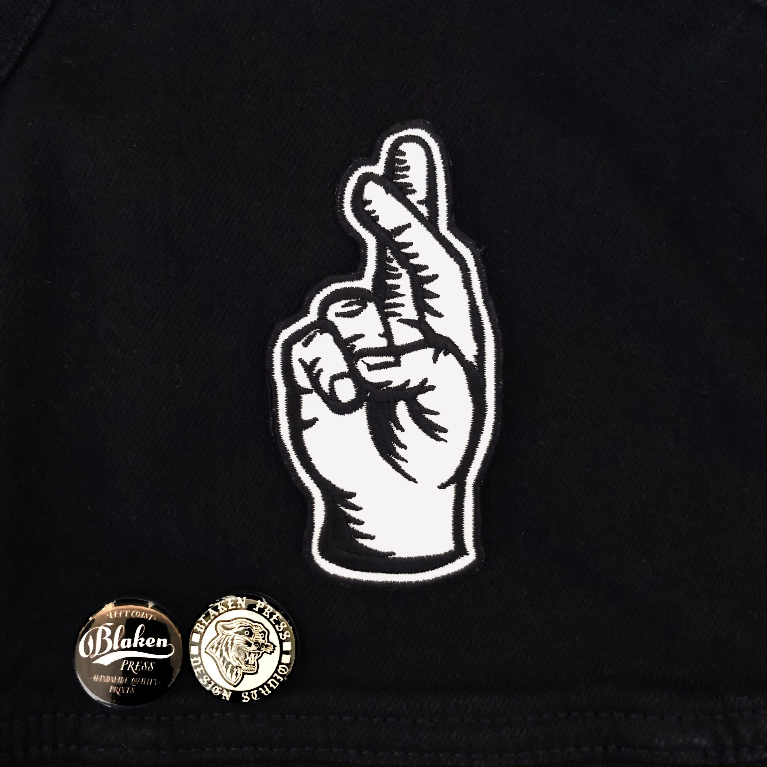 fingers crossed on jacket patch.jpg