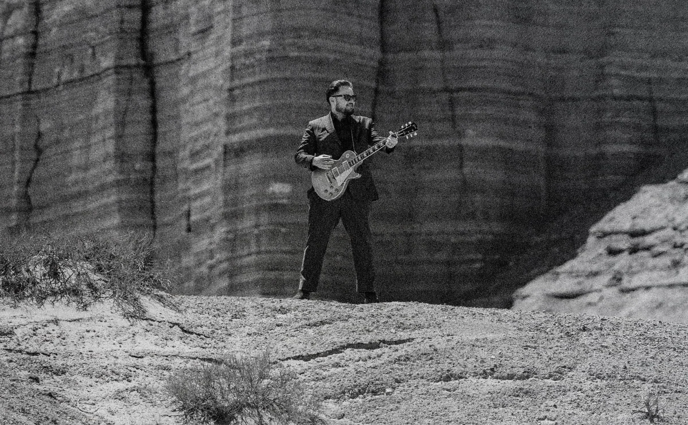 Wyatt Lowe Playing Guitar in Desert