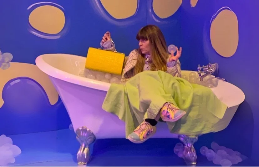 Liv relaxing in a bathtub, bringing a playful, personal touch to the Let's Natter counselling website.