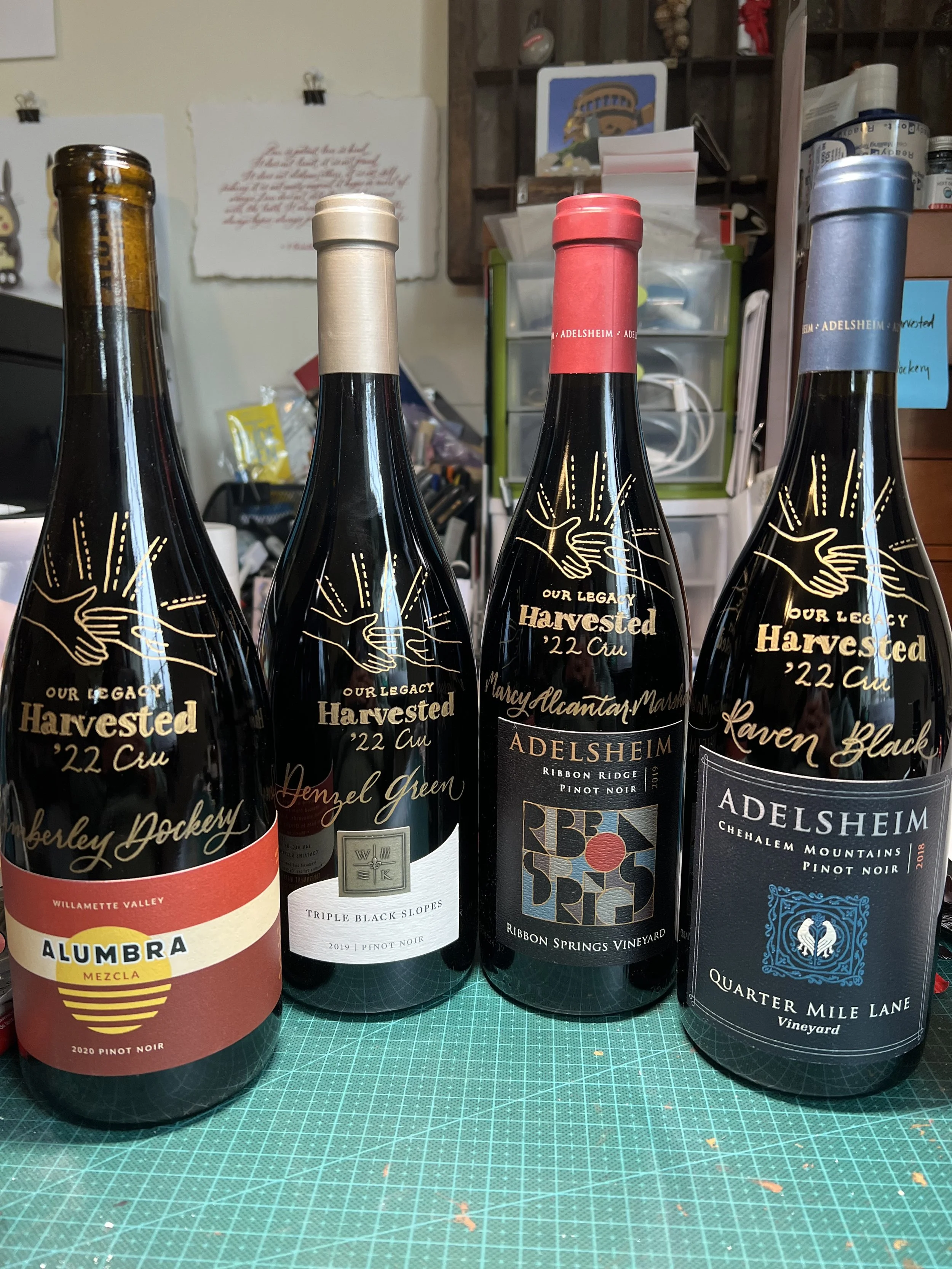 Engraved bottles of win with Our Legacy Harvested logo