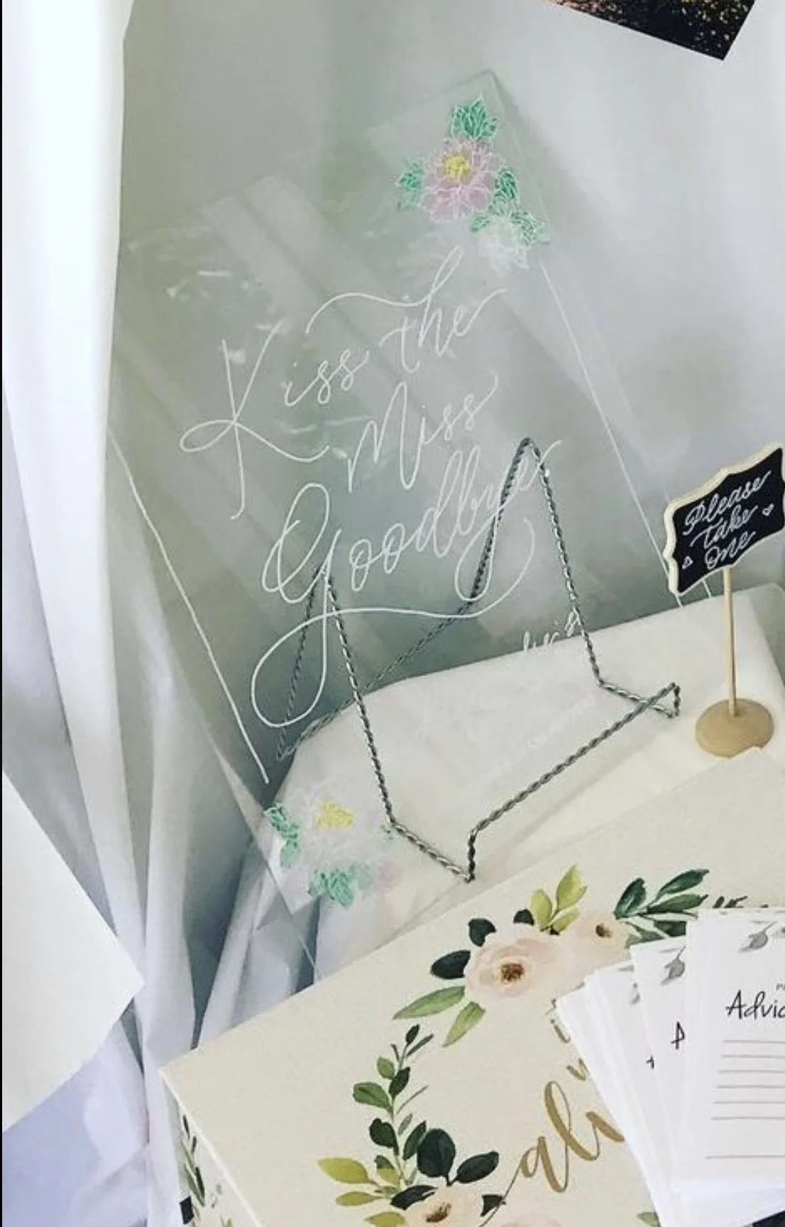 Acrylic sign that says, "Kiss the miss goodbye."