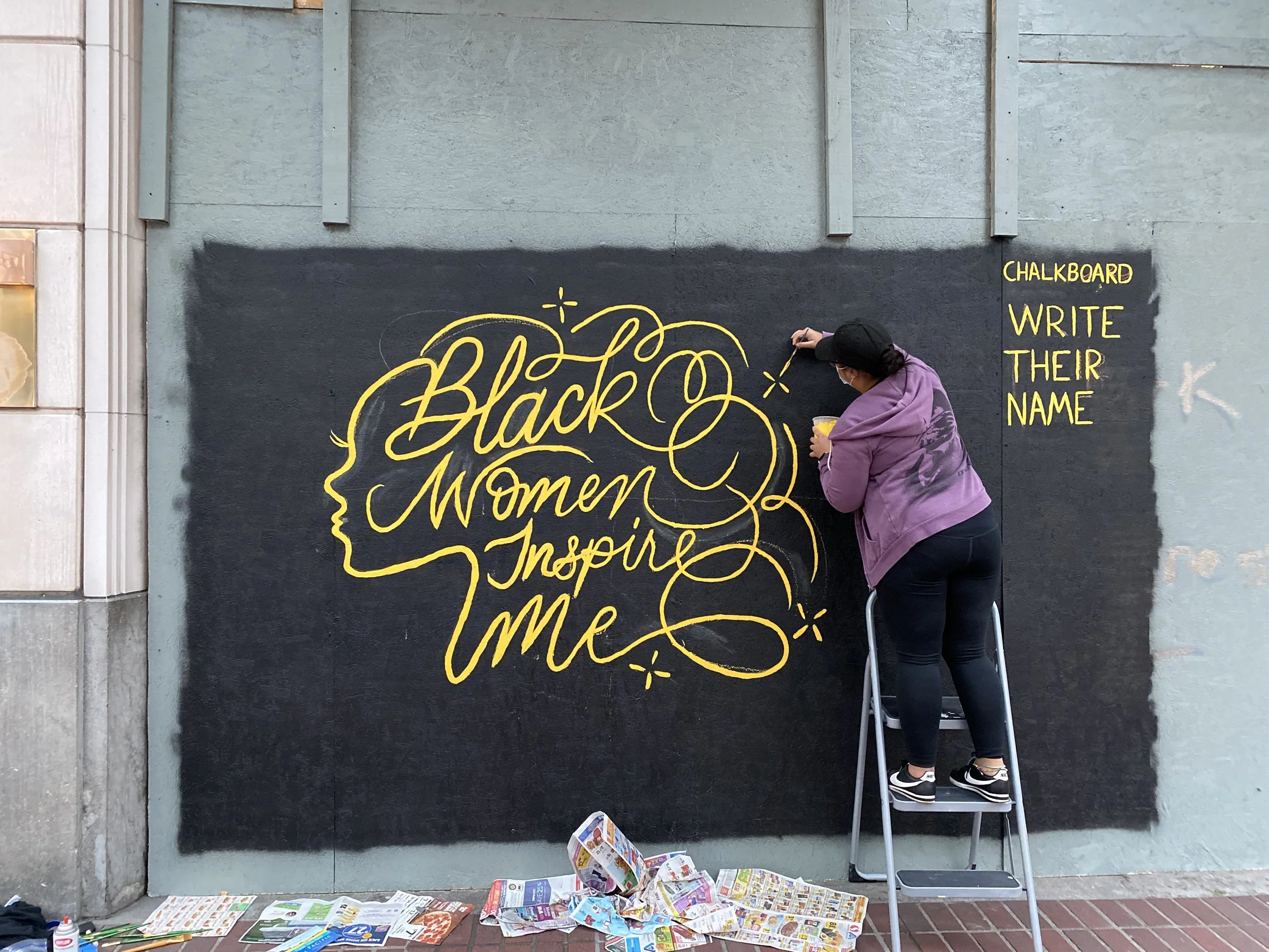 Painted mural that says, "Black Women Inspire Me."