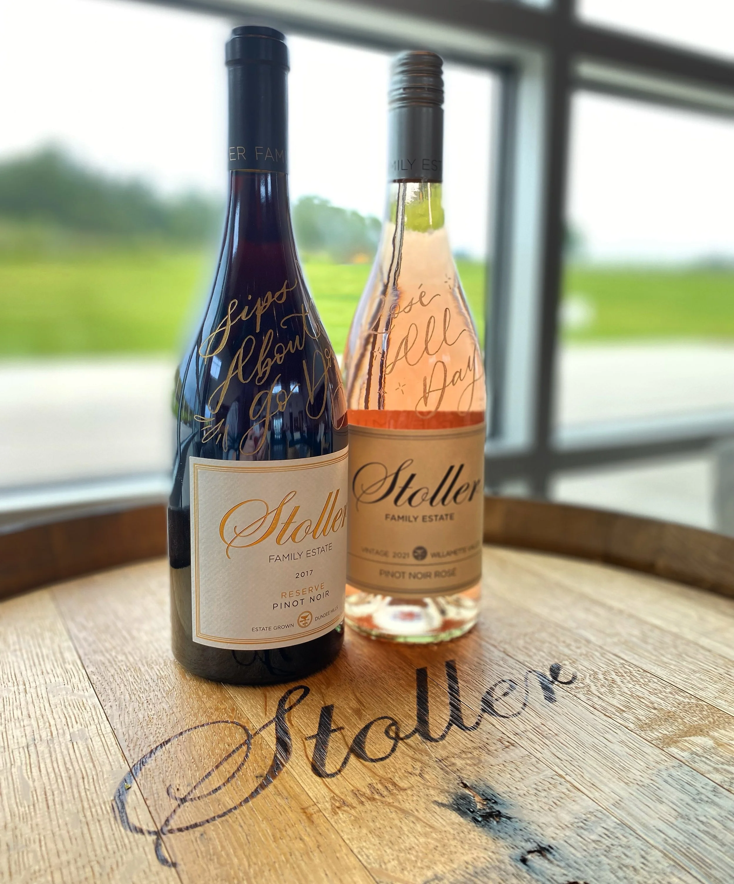 Two bottles of Stoller wine with sayings on them