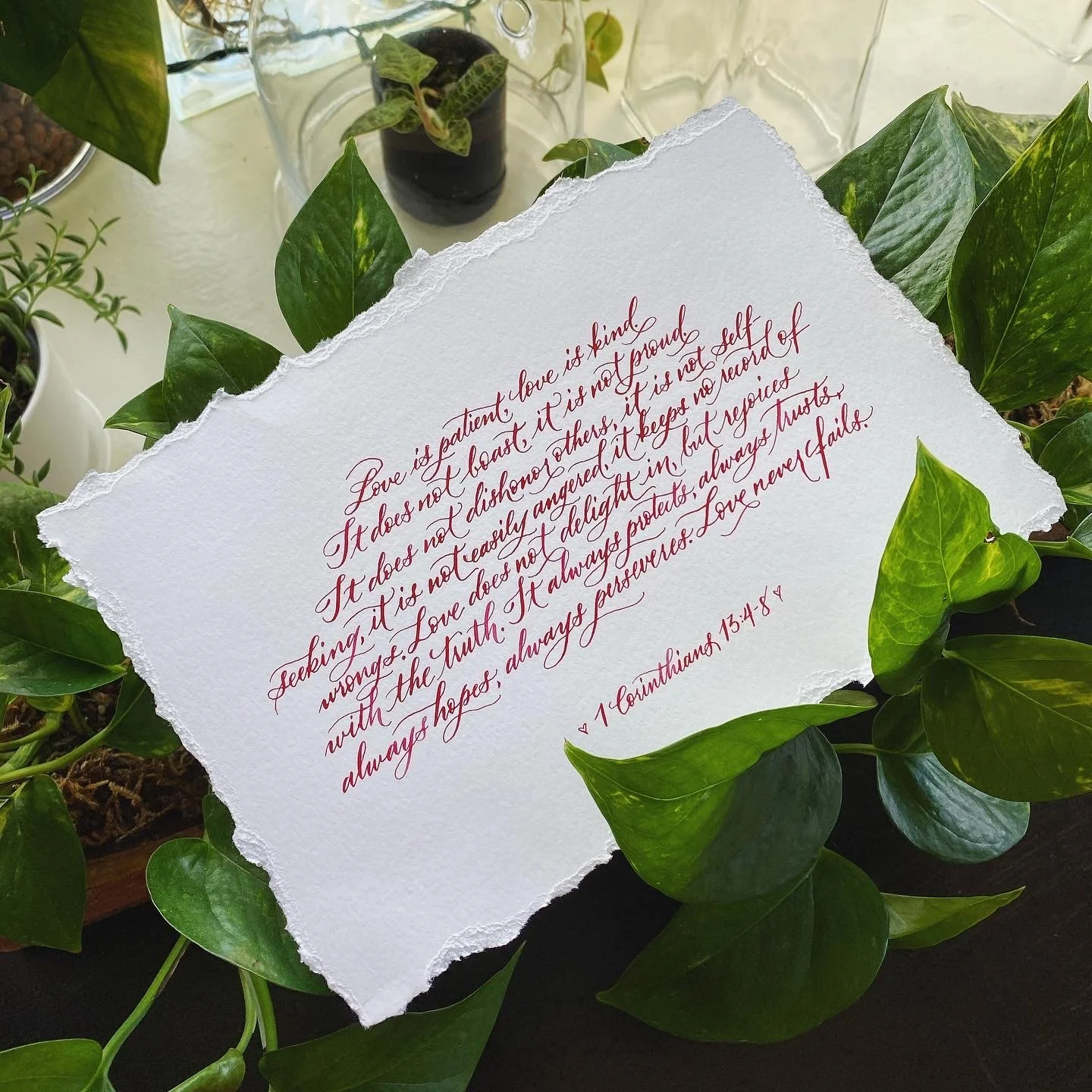 Paper written on with red ink with the bible verse that begins with, "Love is patient, love is kind..."