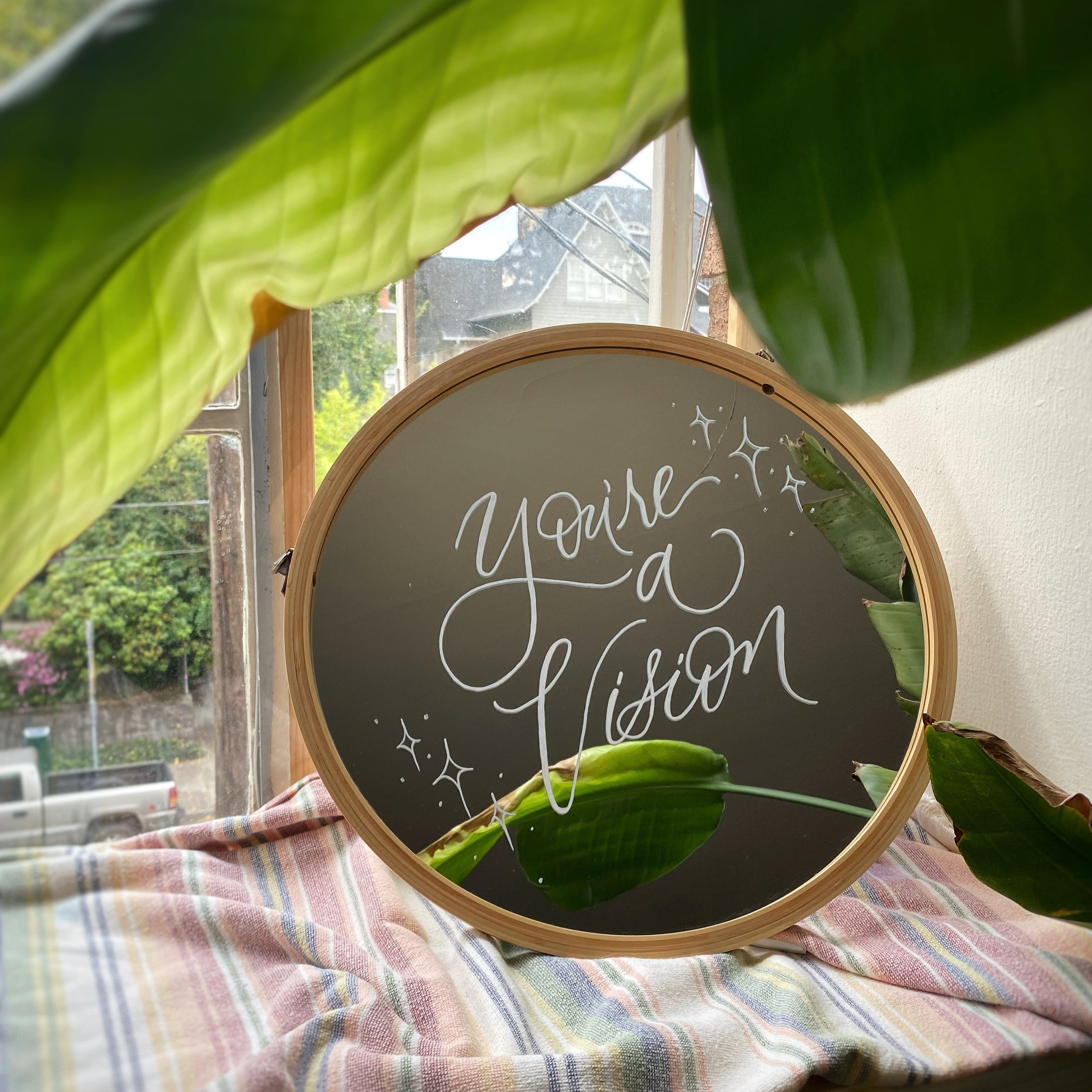 Mirror decorated with the phrase, "You're a vision.'