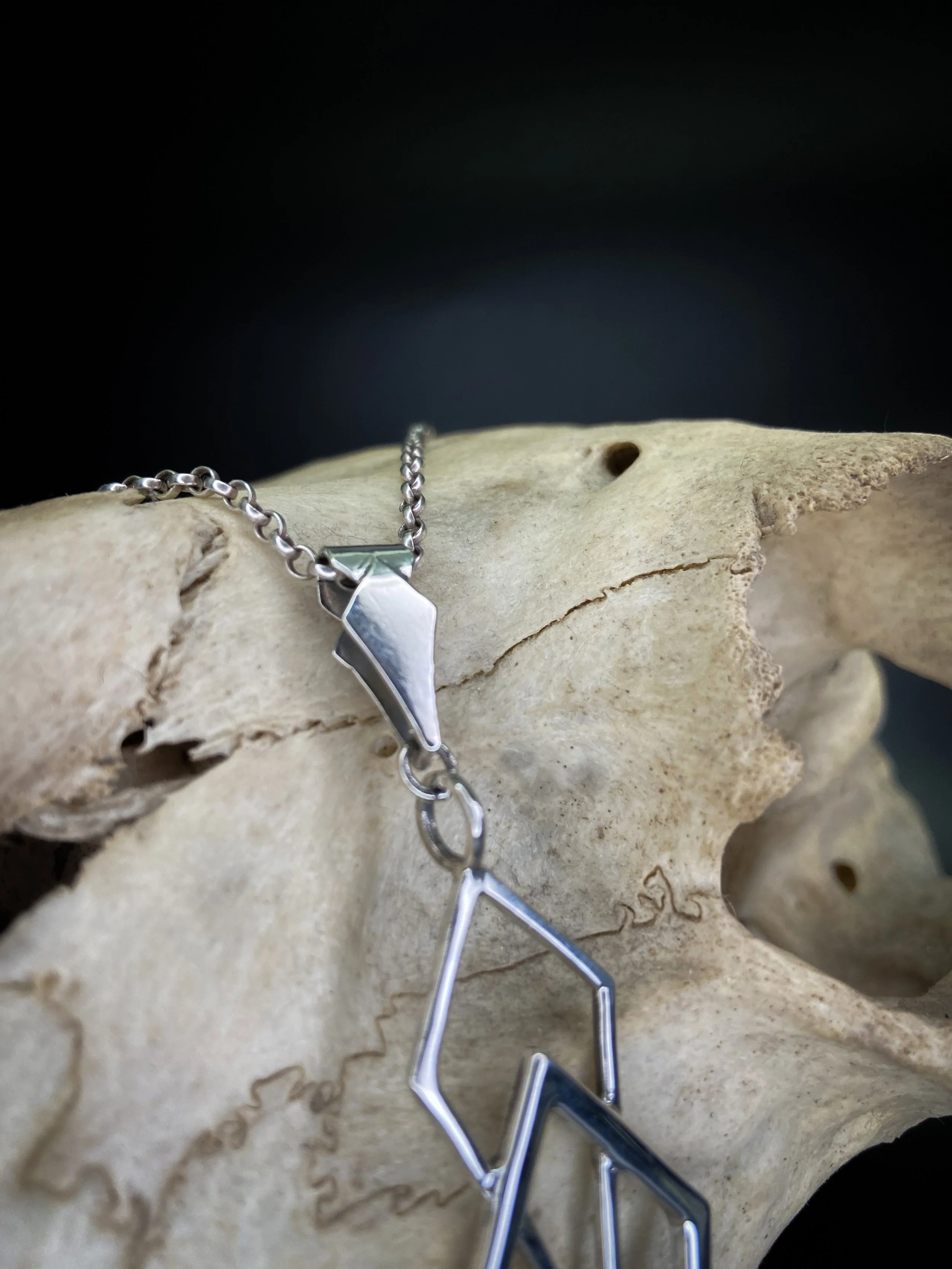 hand made silver pendant designed and made by fmdtattoos London tattoo and jewellery maker silver geometric charm sacred geometry trapezoid jewelry