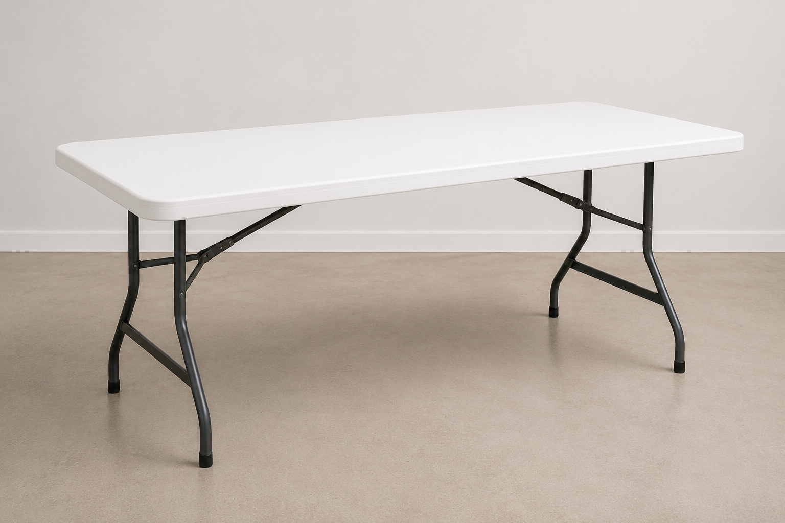 White folding table with metal legs set against a plain white wall and beige carpeted floor.