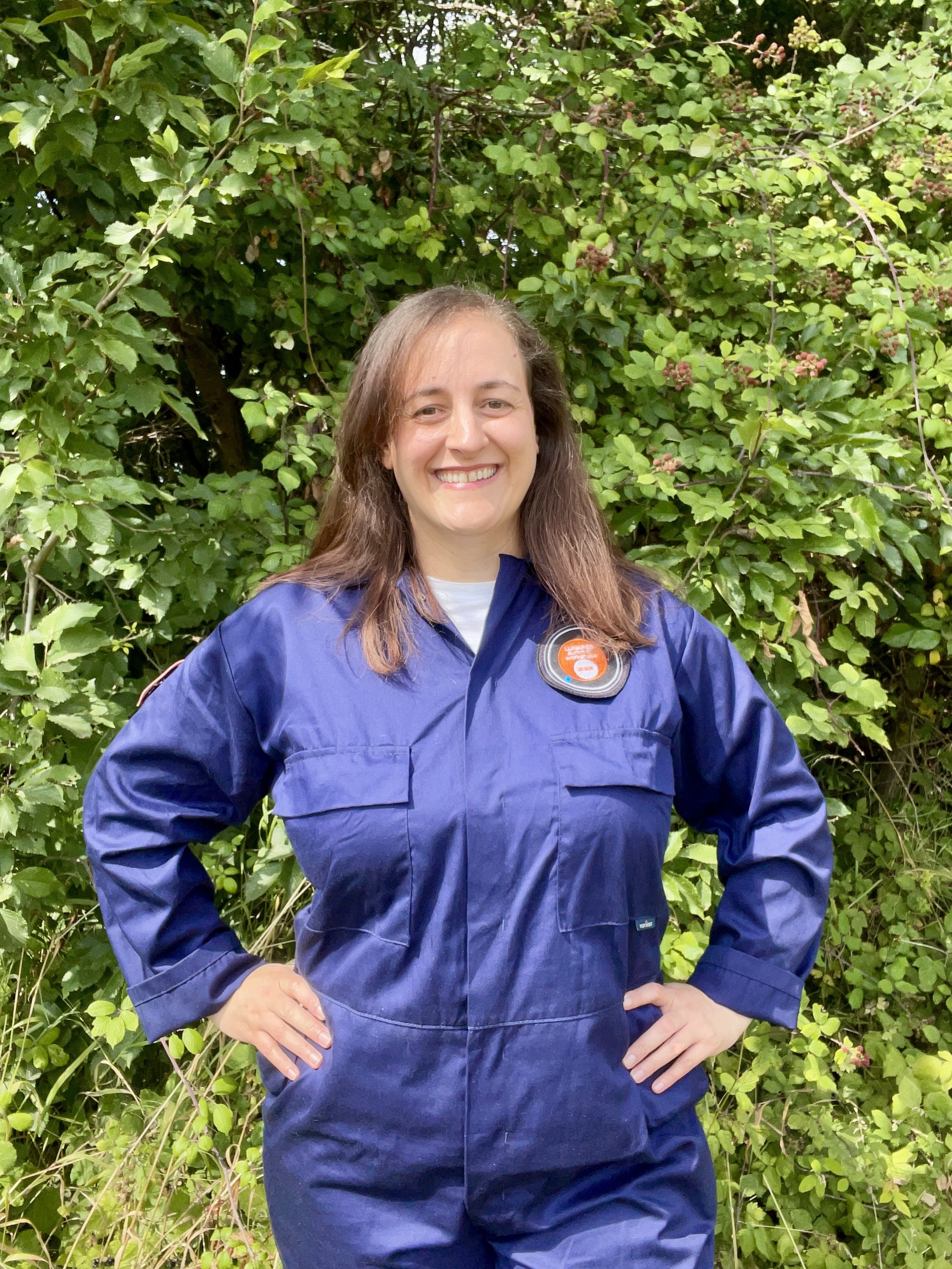 Caroline Clark in her blue analogue astronaut flightsuit