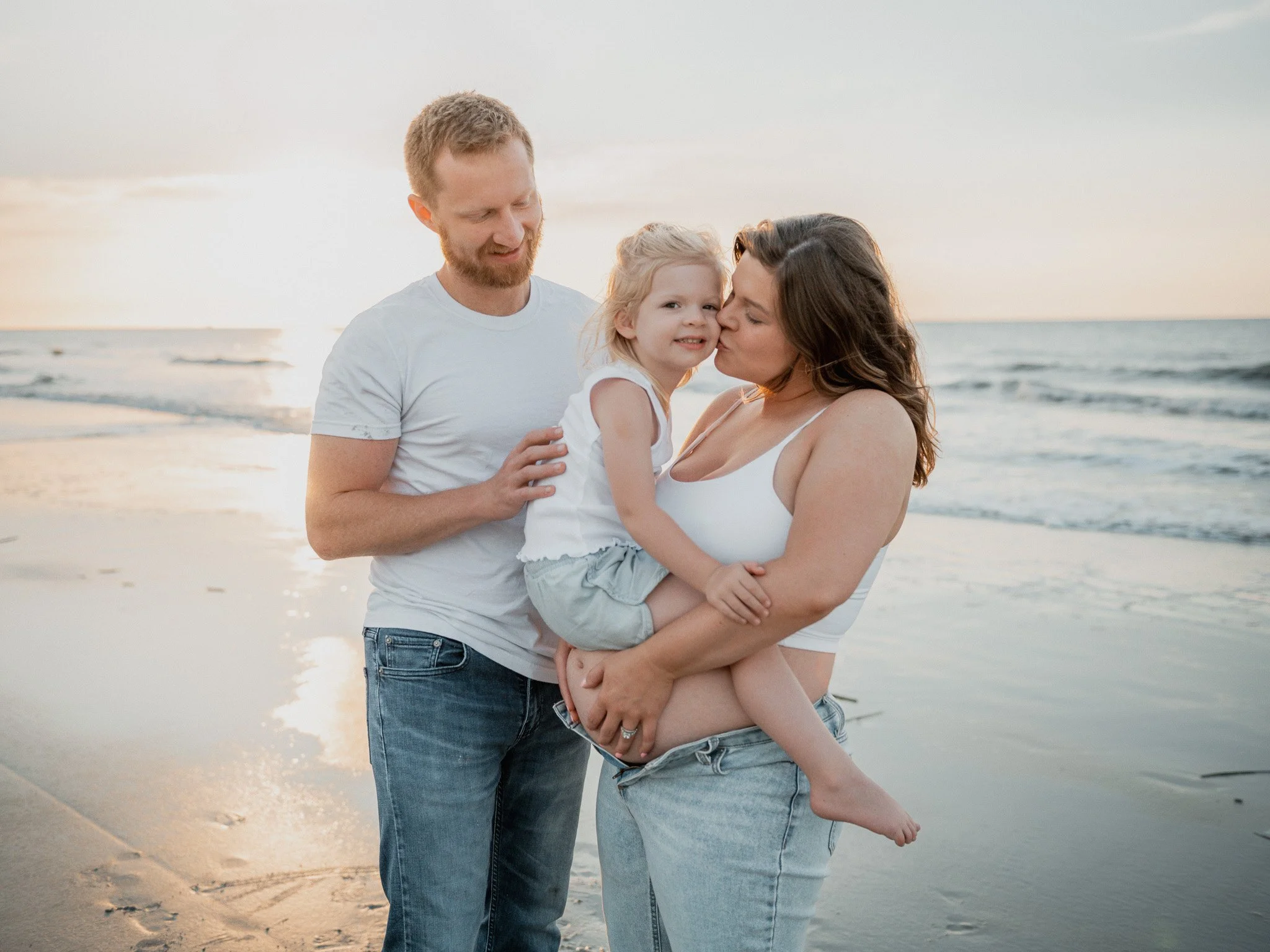 Family of three posing for maternity photoshoot on Hunting Island Beach