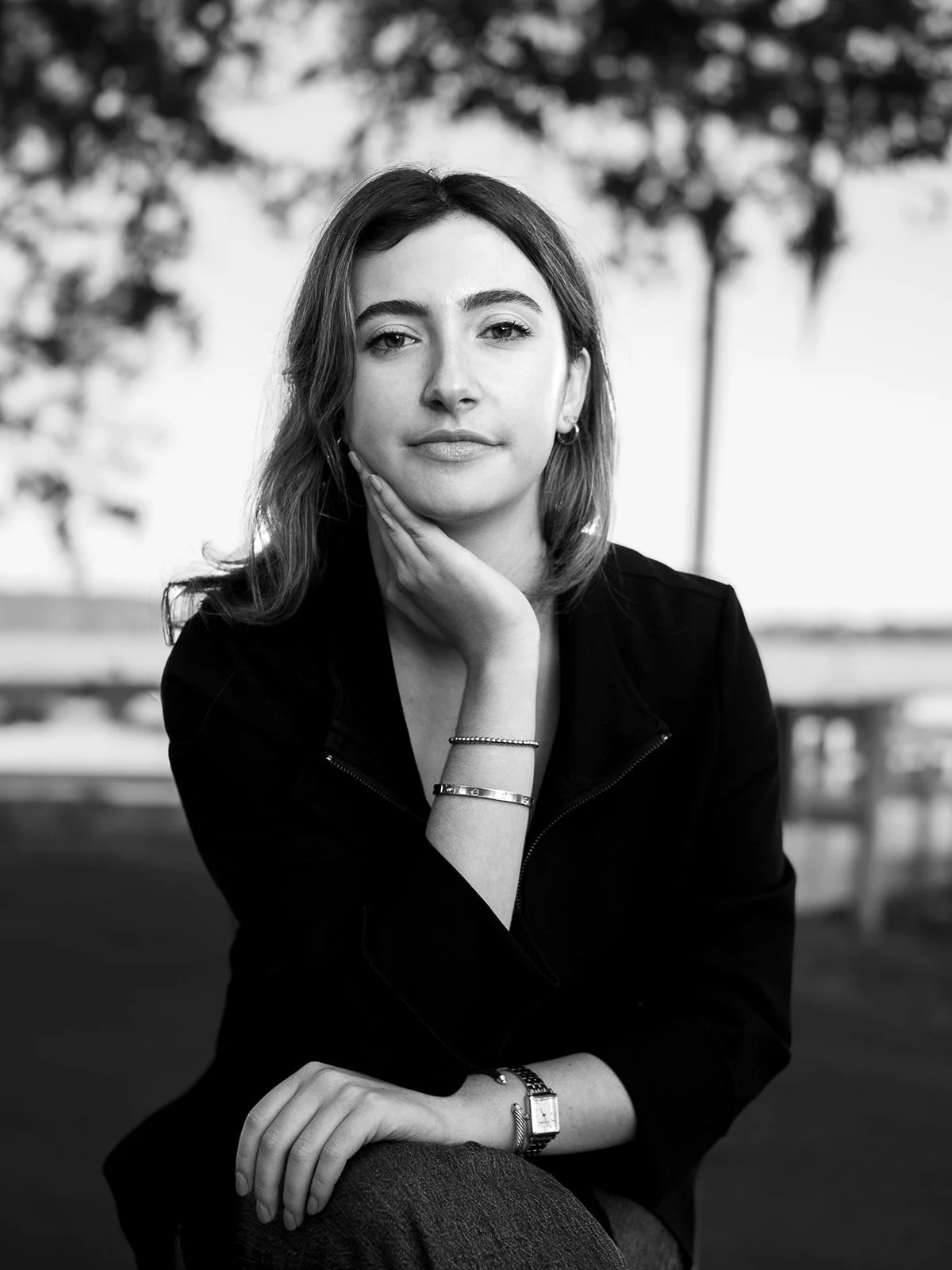 Black‑and‑white headshot of a woman with a gentle smile and soft lighting.