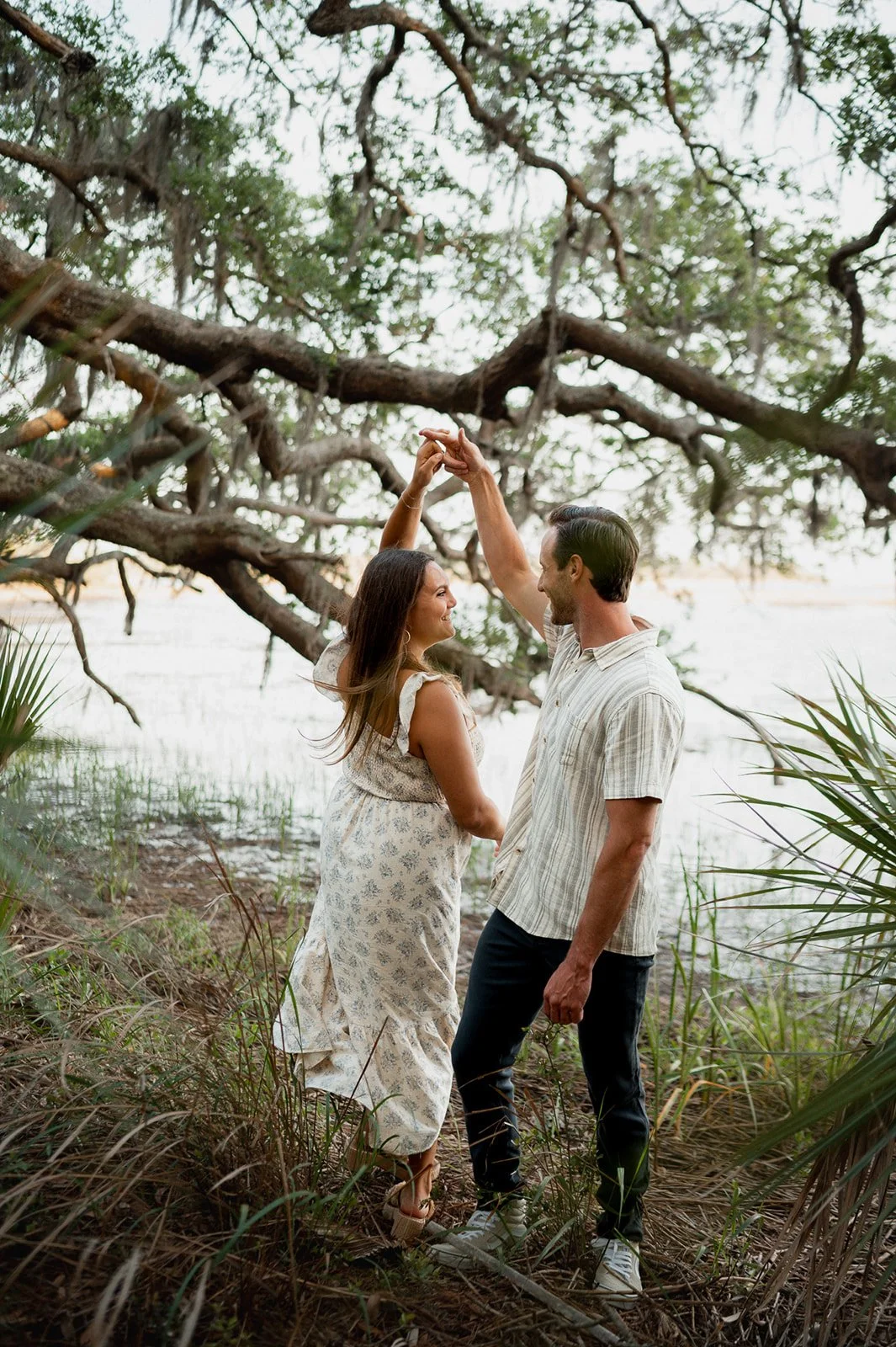Couple dancing under a sprawling oak tree draped with Spanish moss in Beaufort.
