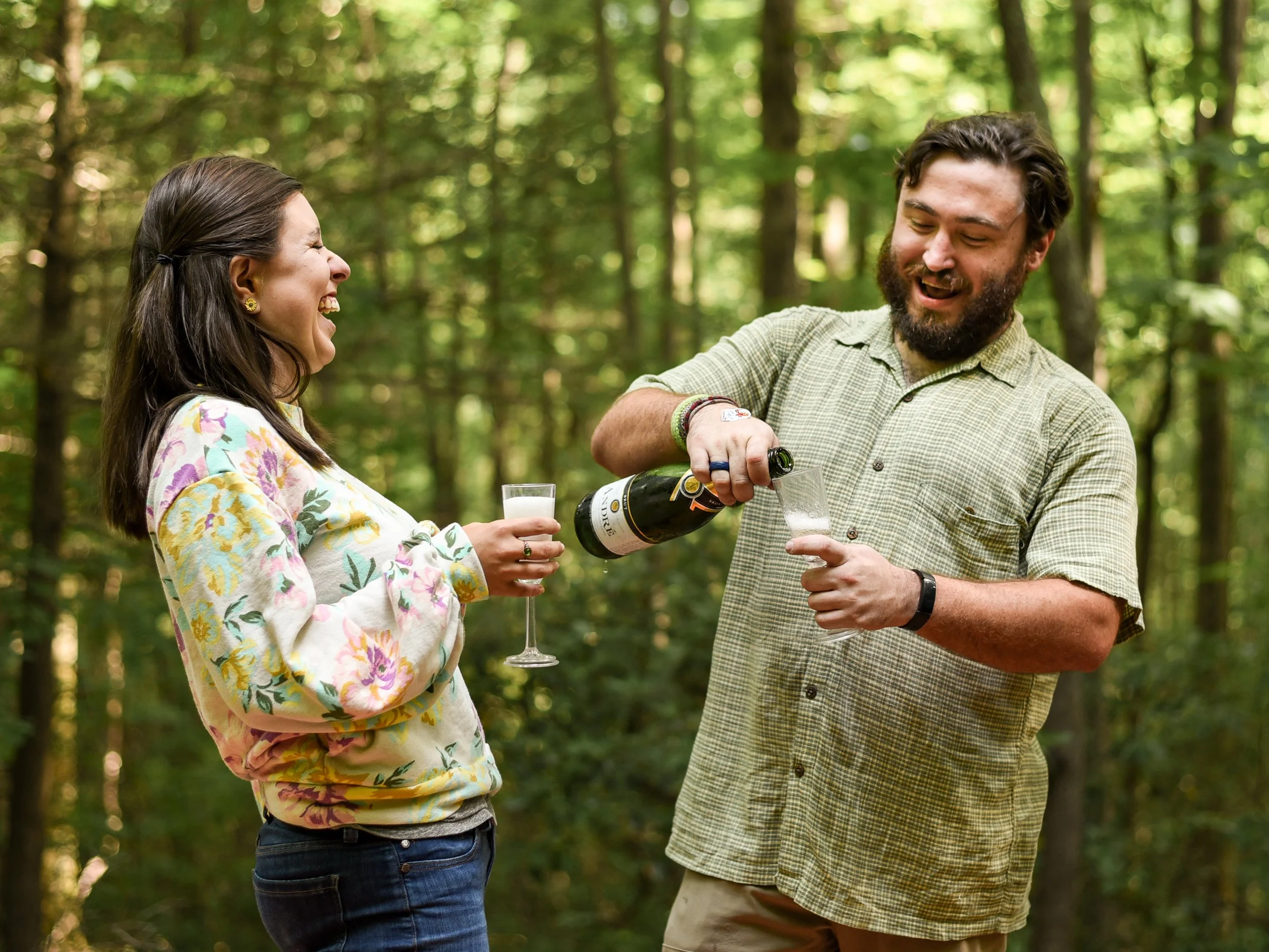 Guests laughing together and enjoying refreshments at an outdoor party.