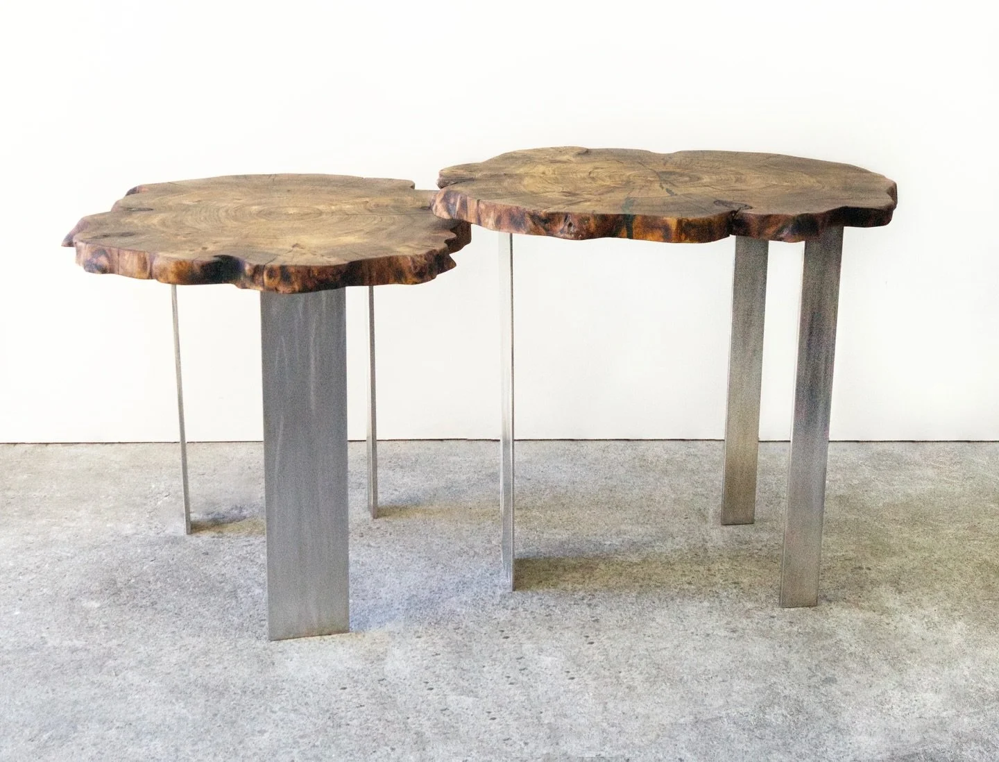Live Edge Table was designed in collaboration with interior designer Tina Voight. Working from slabs of a 150-year-old elm trunk, the goal was to create a contemporary piece that could function as a desk. The stainless steel base provides a sense of 