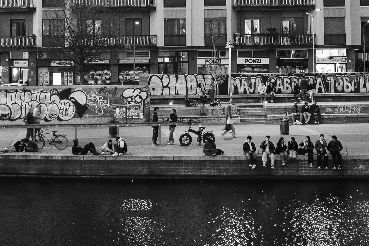 Black and white street photograph along the Navigli in Milan with strong framing by Annah Kim Nelson-Feeney